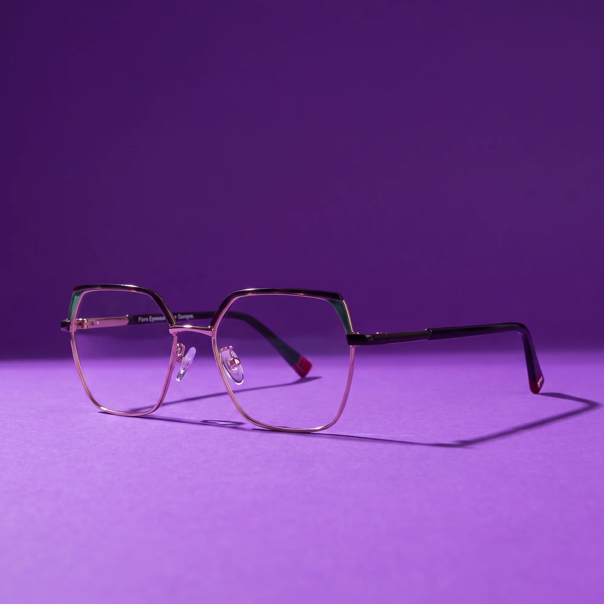 Fiore 3971 eyeglasses in black gold – hero still life against a deep violet backdrop