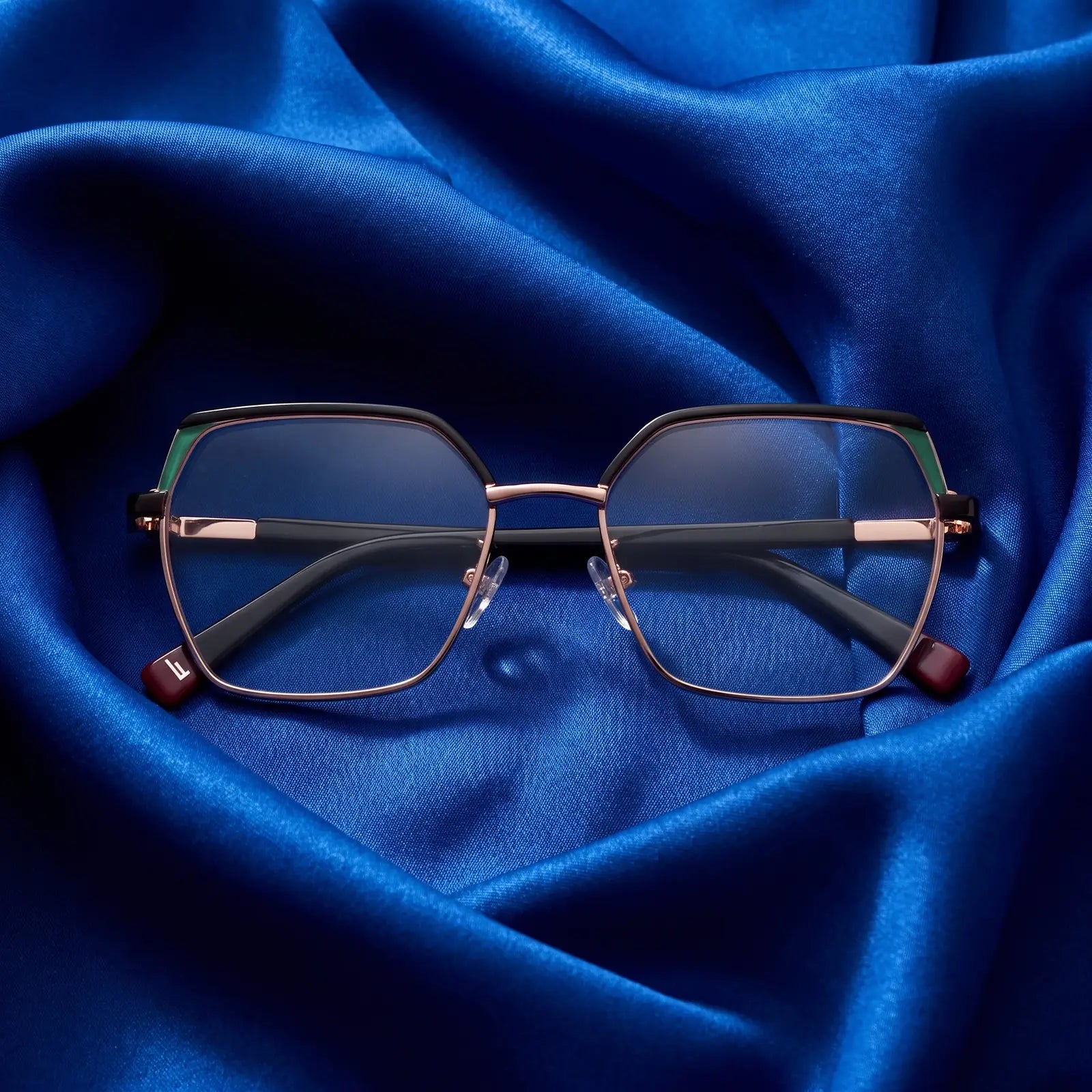 Fiore 3971 eyeglasses in black gold – nested in flowing cobalt silk