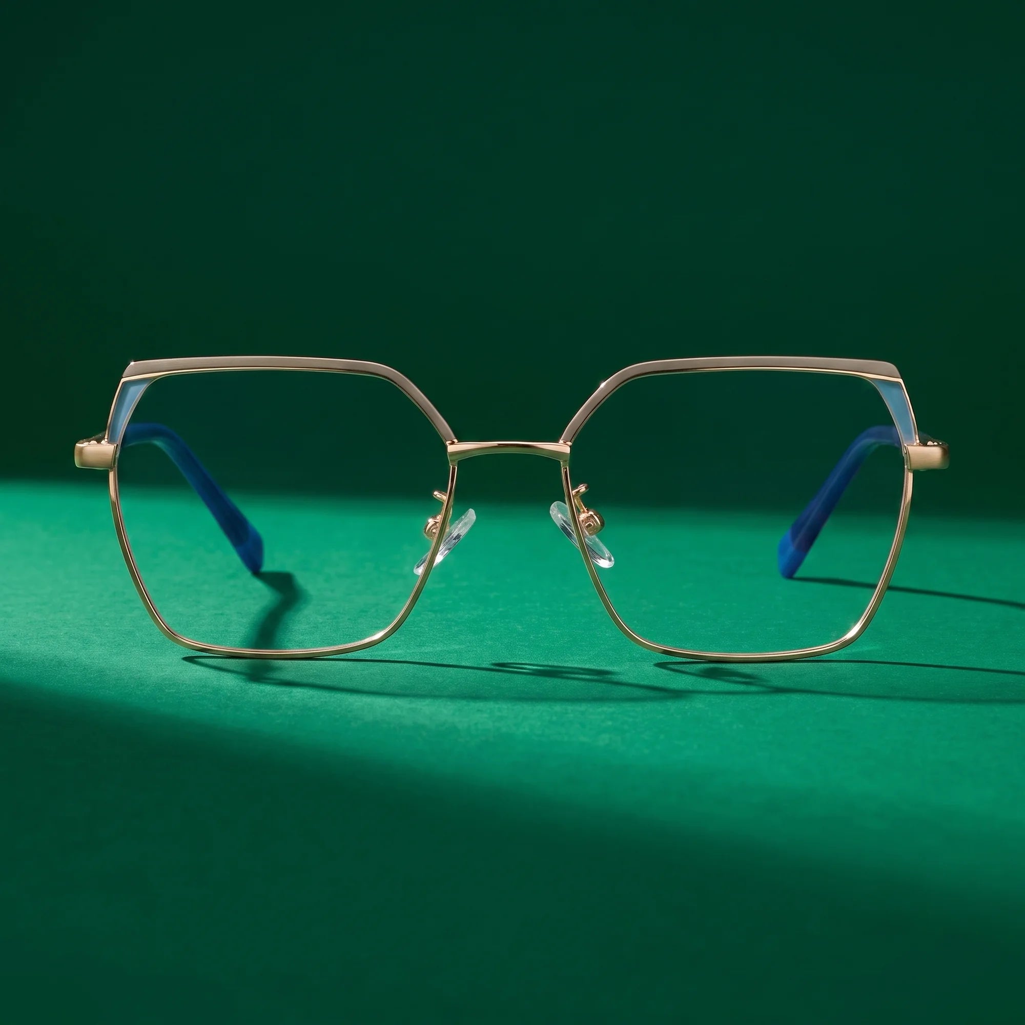 Fiore 3971 eyeglasses in grey gold – still life on a seamless emerald studio backdrop