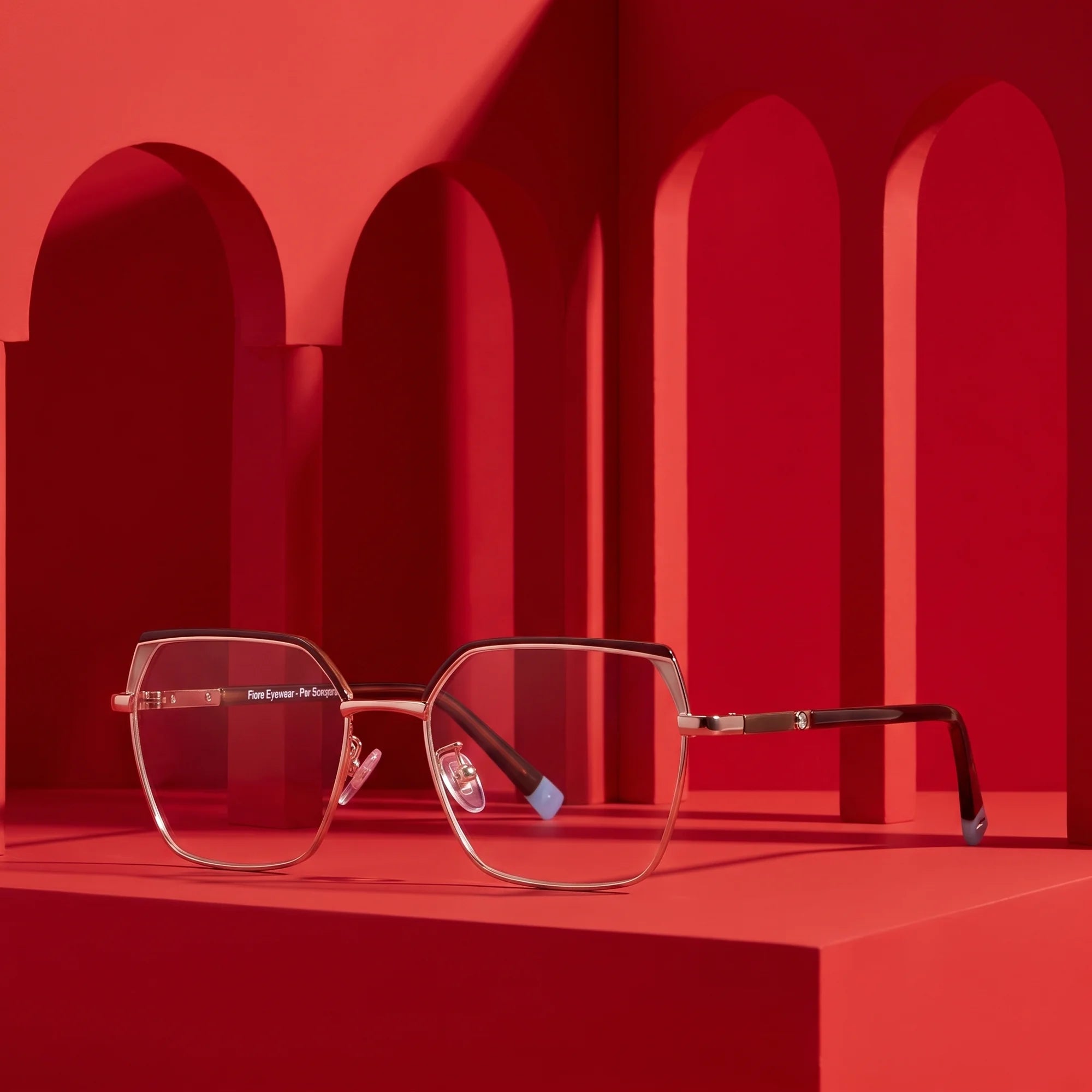 Fiore 3971 eyeglasses in brown gold – staged on a sculptural vivid red architecture set