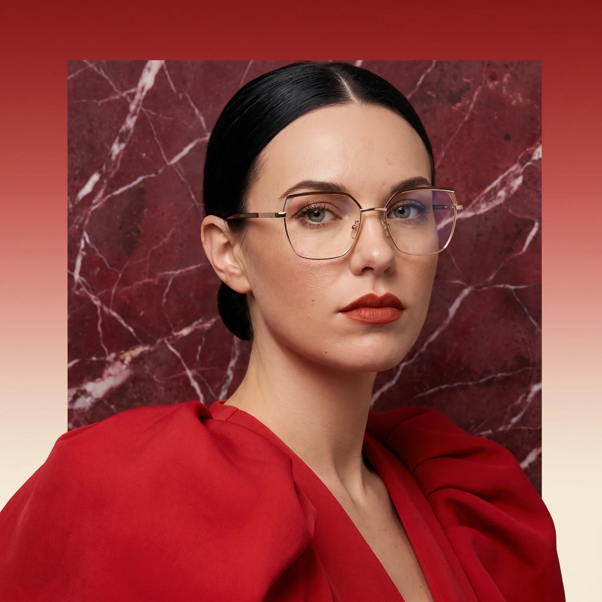 Fiore 3971 eyeglasses in brown gold, worn by a model – campaign portrait, red marble backdrop and draped scarlet dress