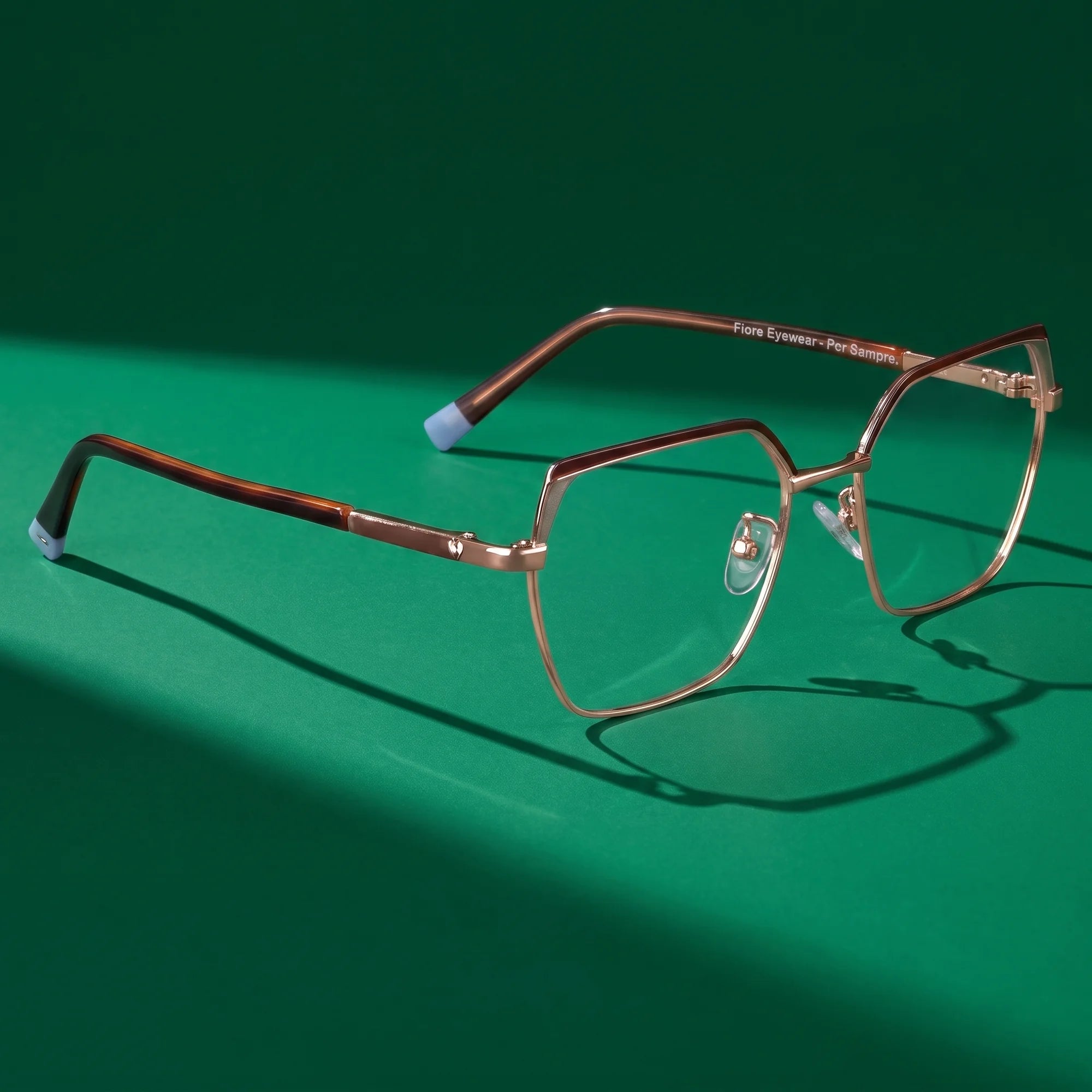 Fiore 3971 eyeglasses in brown gold – editorial still life on a saturated emerald set