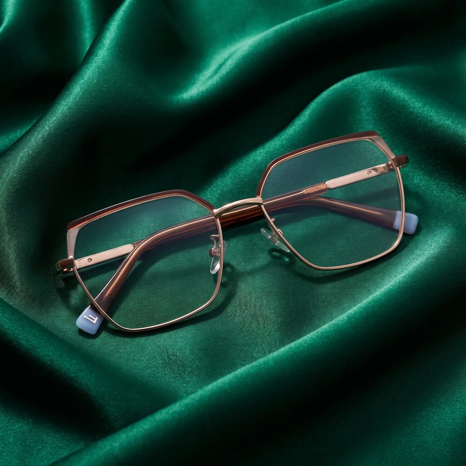 Fiore 3971 eyeglasses in brown gold – nested in flowing emerald silk