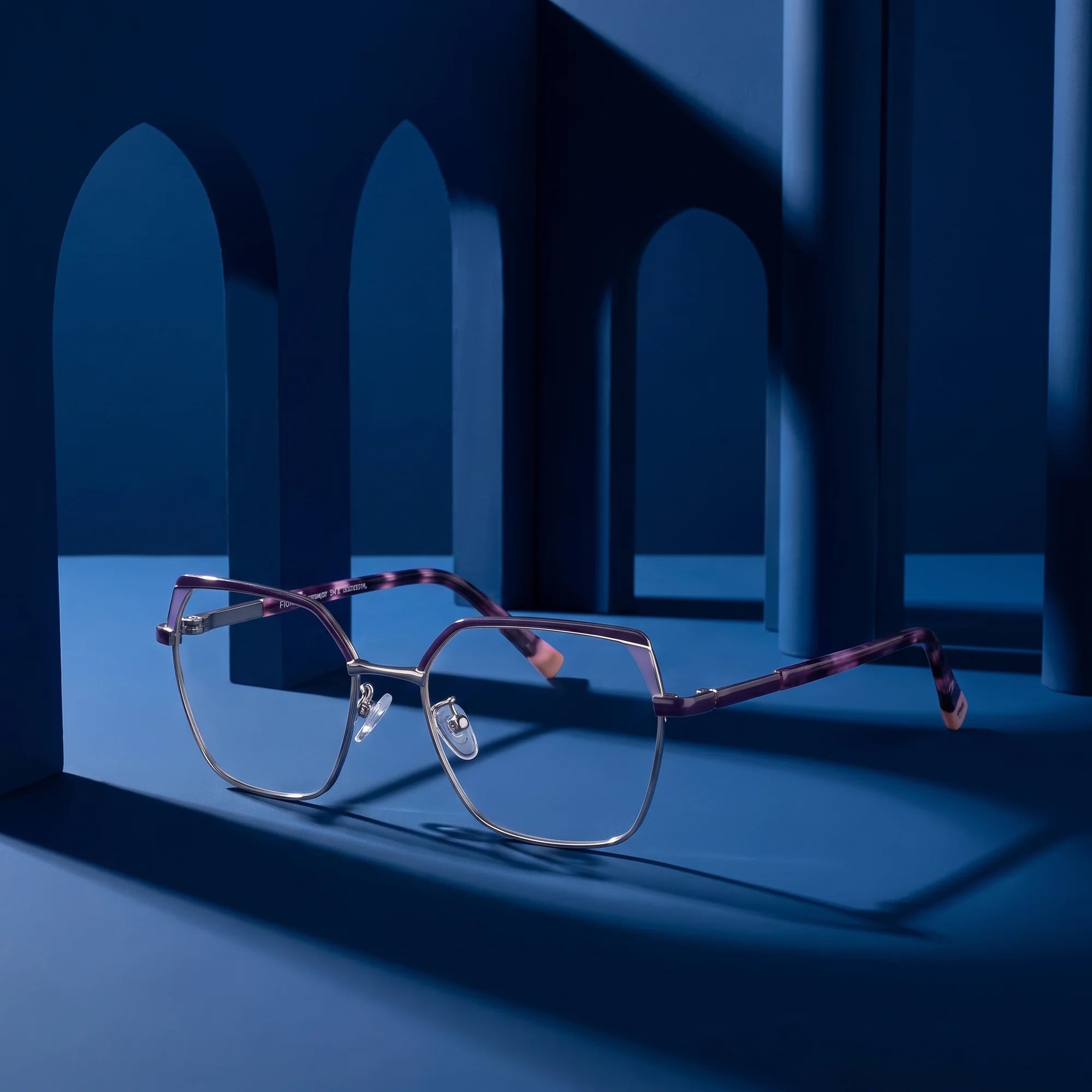 Fiore 3971 eyeglasses in purple silver – staged on a sculptural midnight blue architecture set