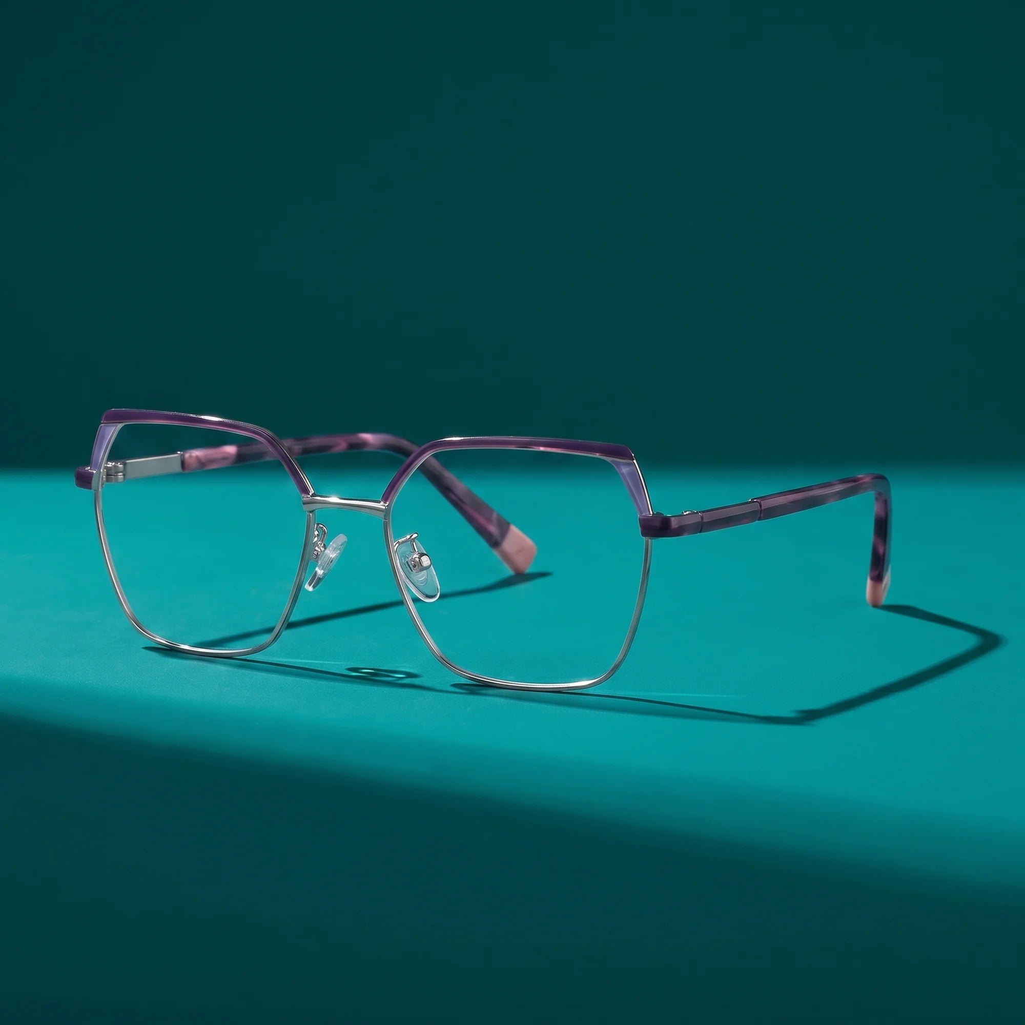 Fiore 3971 eyeglasses in purple silver – still life on a seamless teal studio backdrop