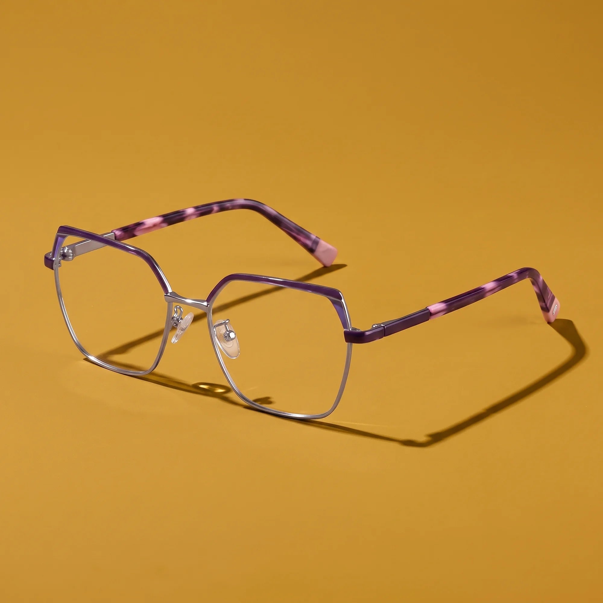 Fiore 3971 eyeglasses in purple silver – hero still life against a deep mustard ochre backdrop