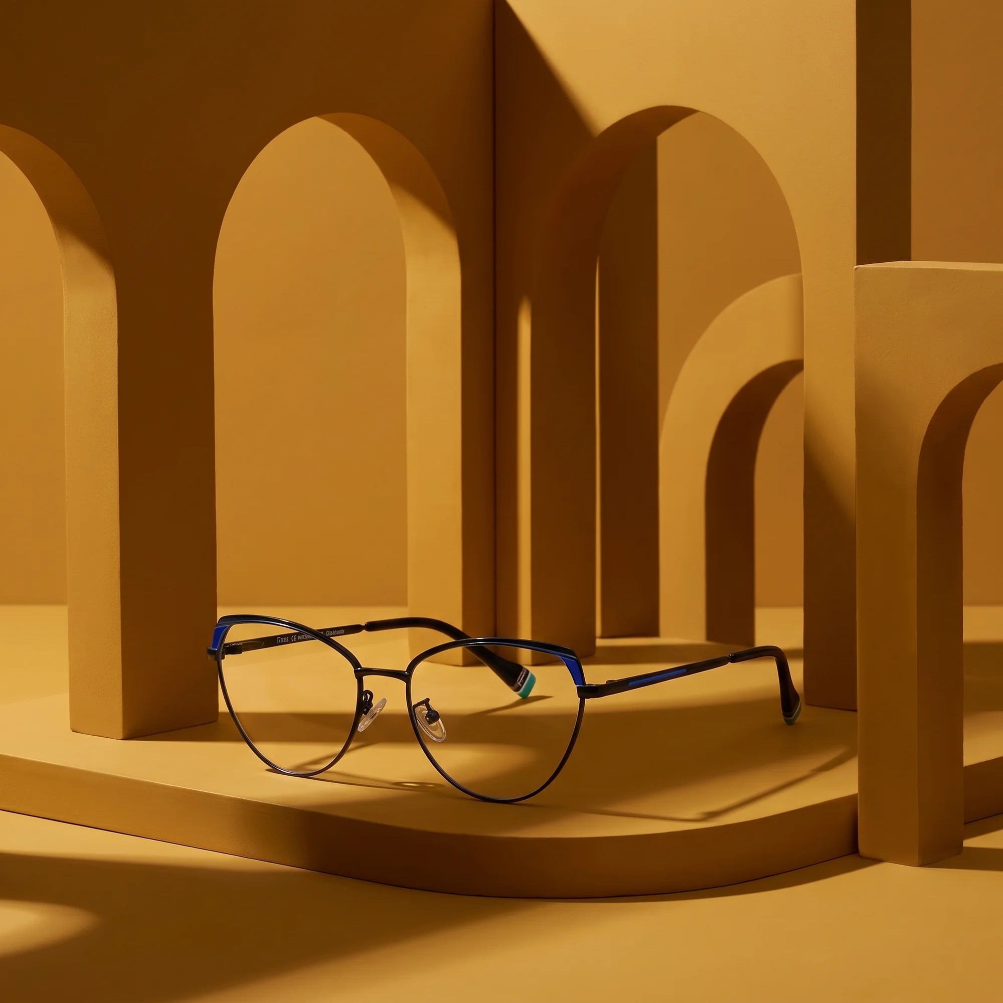 Fiore 3983 eyeglasses in black blue – still life among monochrome mustard ochre arches