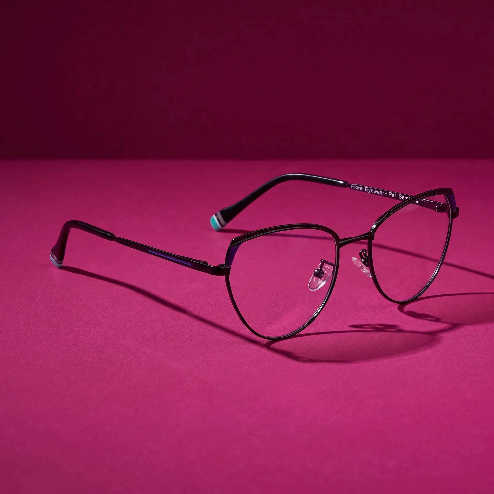 Fiore 3983 eyeglasses in black blue – hero still life against a deep magenta backdrop