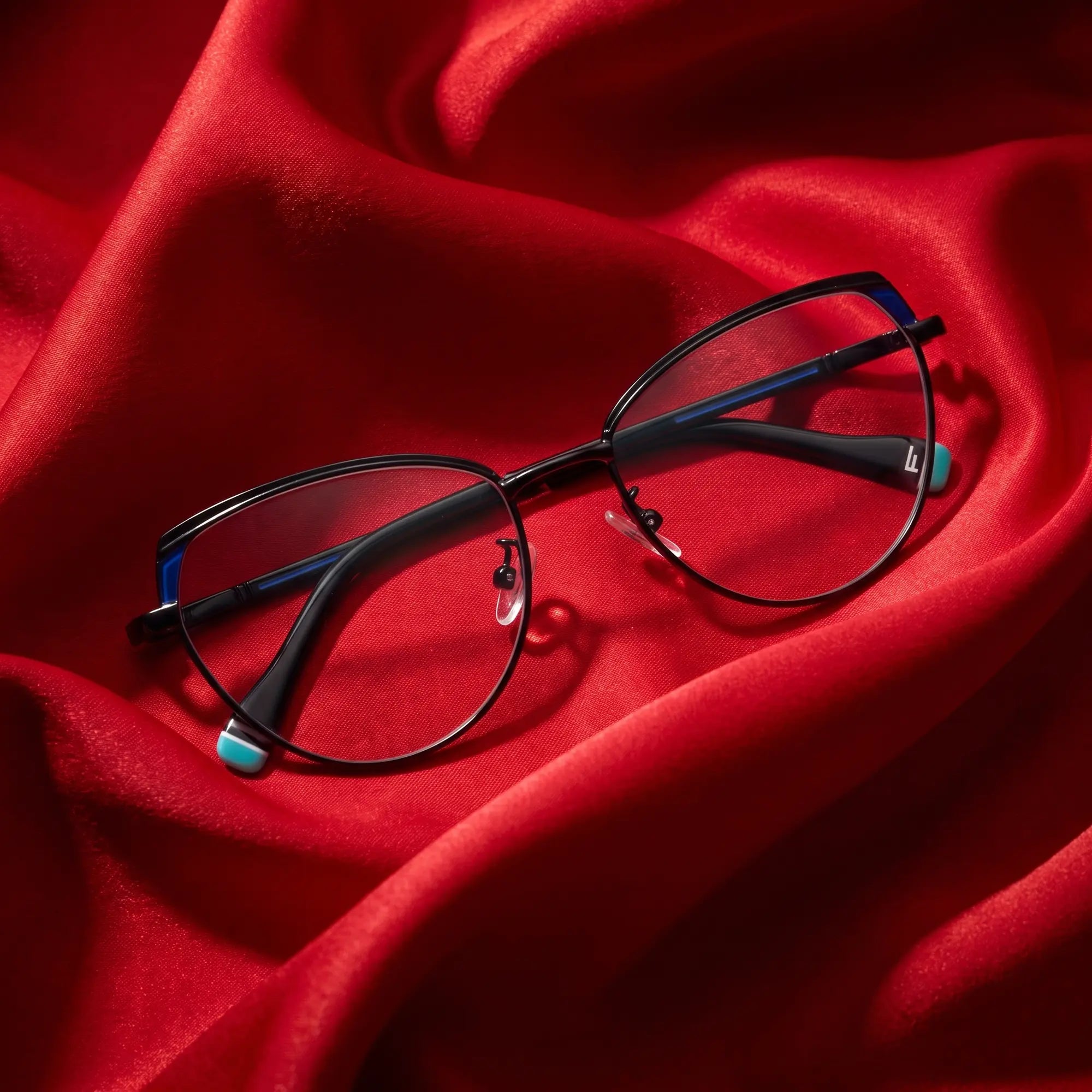 Fiore 3983 eyeglasses in black blue – nested in flowing vivid red silk