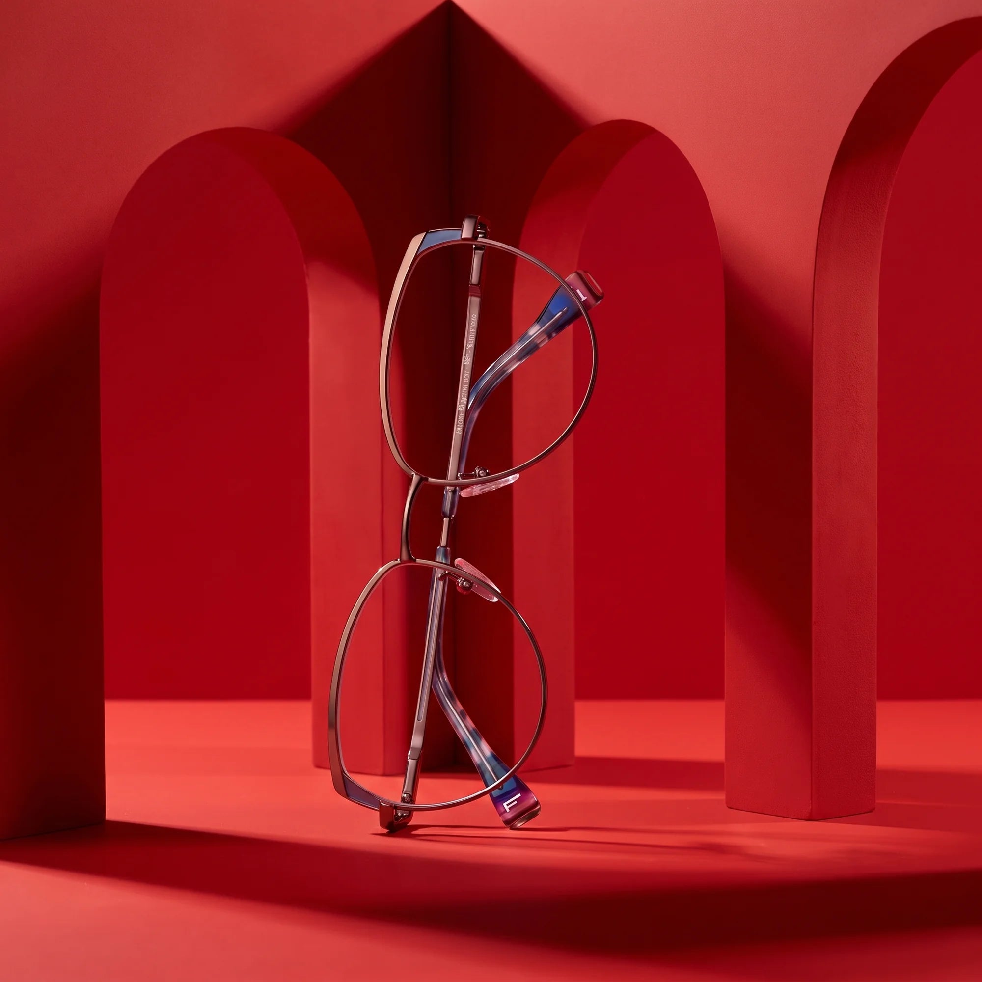 Fiore 3983 eyeglasses in grey gun – staged on a sculptural vivid red architecture set