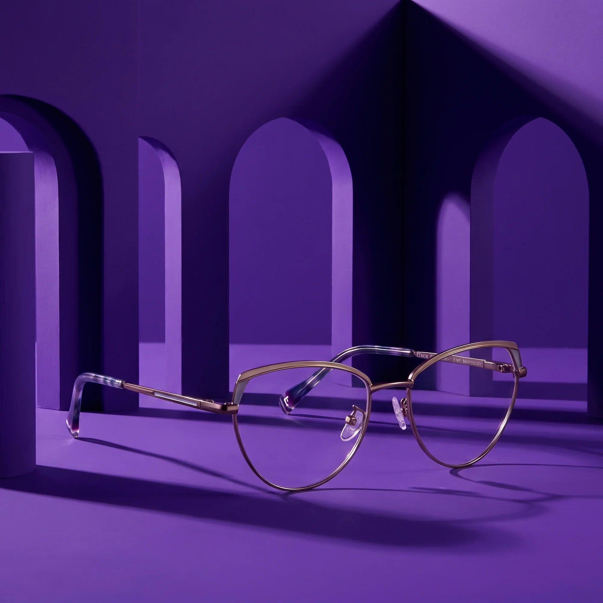 Fiore 3983 eyeglasses in grey gun – displayed on a violet podium among arches