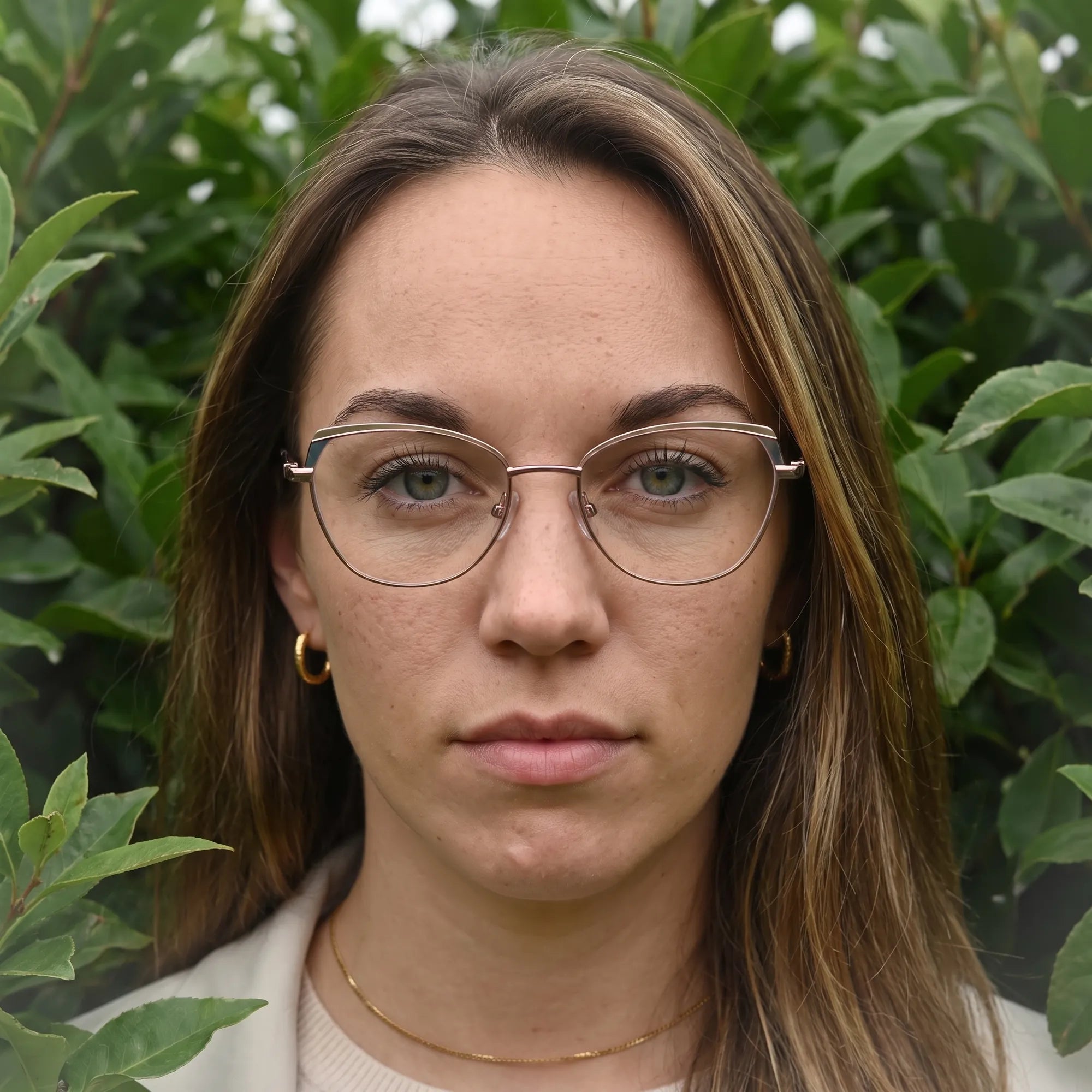 Fiore 3983 eyeglasses in grey gun, worn by a model – campaign portrait, summer daydream in a garden armchair