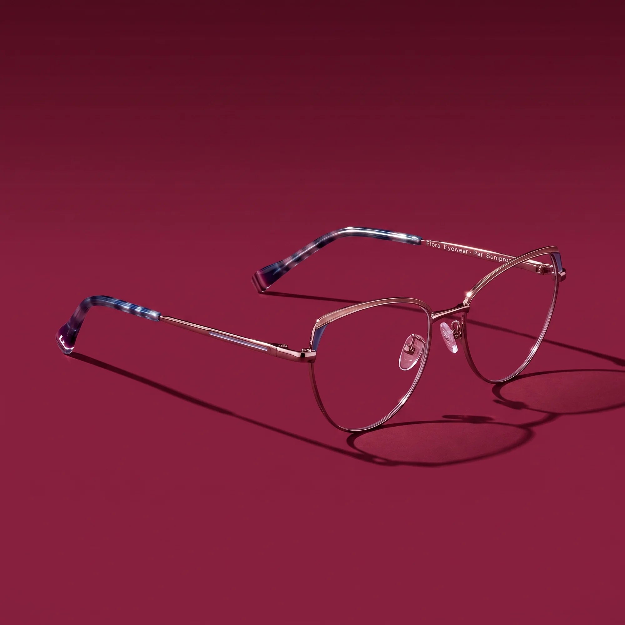 Fiore 3983 eyeglasses in grey gun – editorial still life on a saturated burgundy set