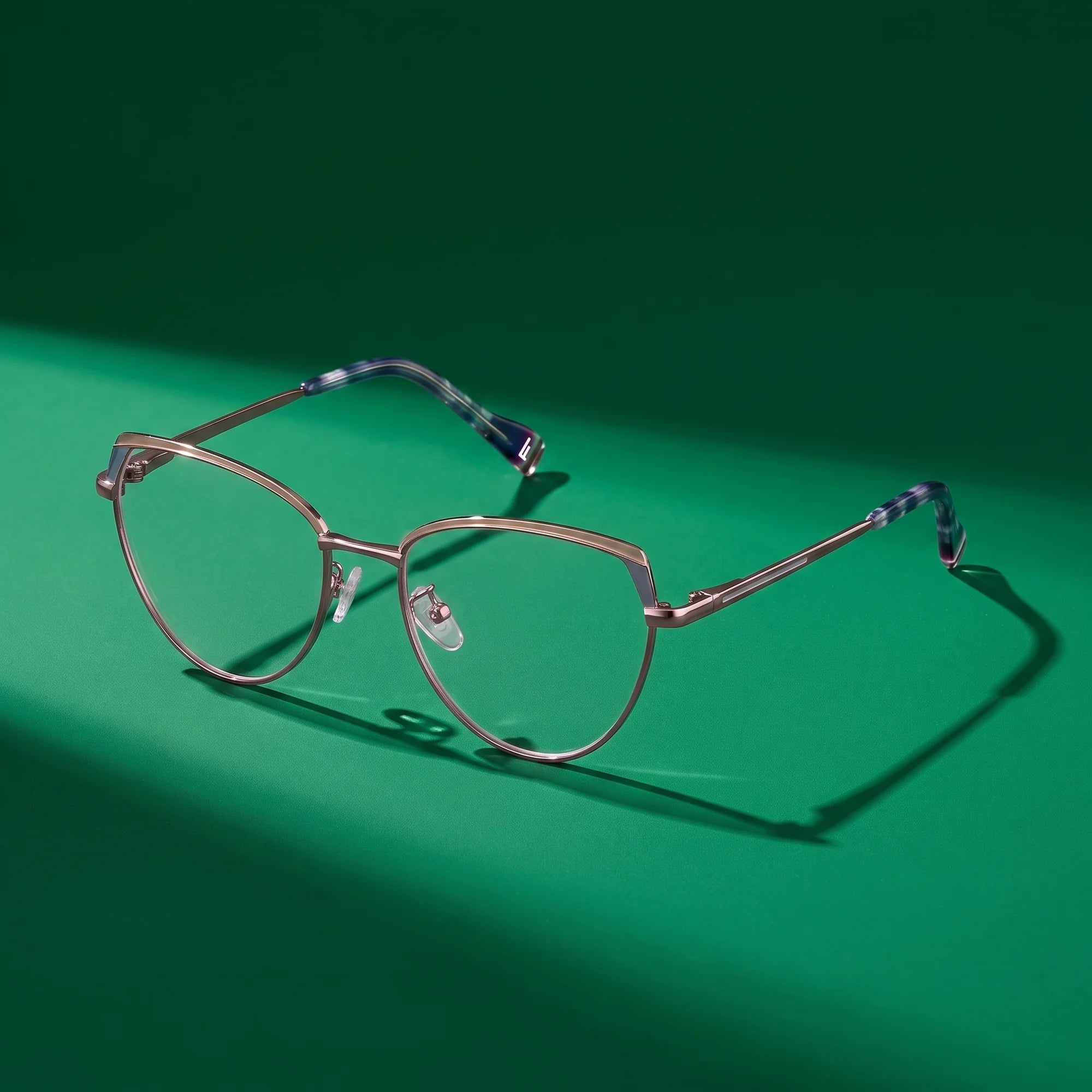 Fiore 3983 eyeglasses in grey gun – still life on a seamless emerald studio backdrop