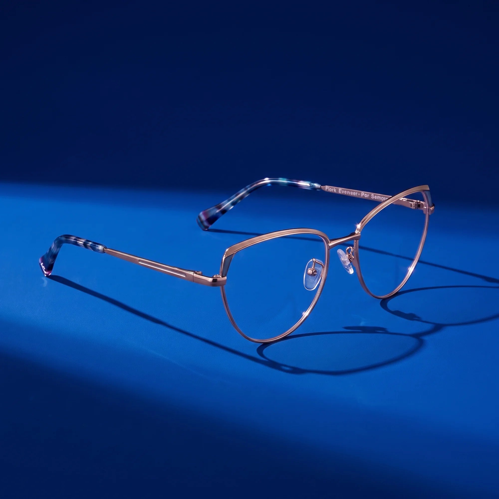 Fiore 3983 eyeglasses in grey gun – hero still life against a deep cobalt backdrop