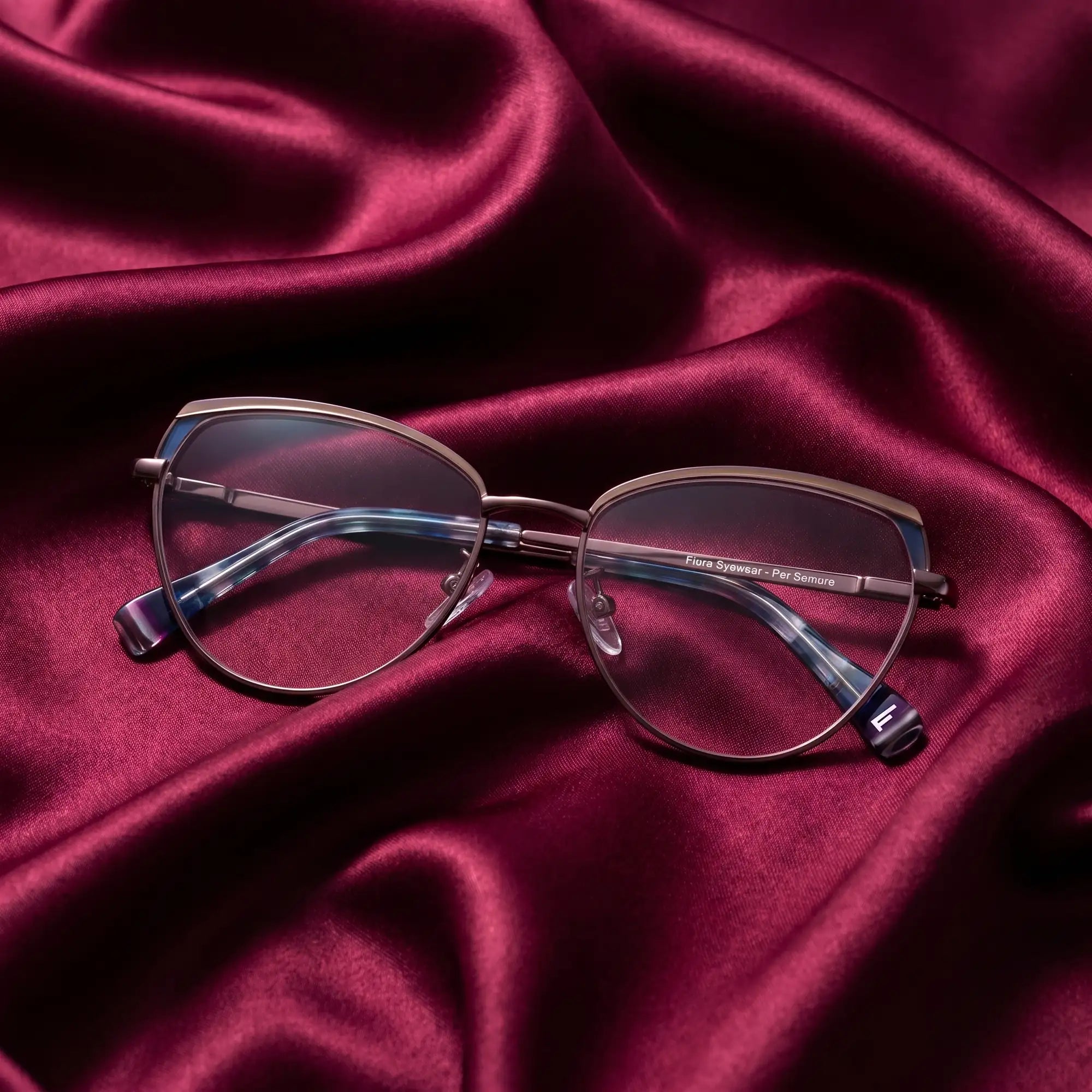 Fiore 3983 eyeglasses in grey gun – nested in flowing burgundy silk