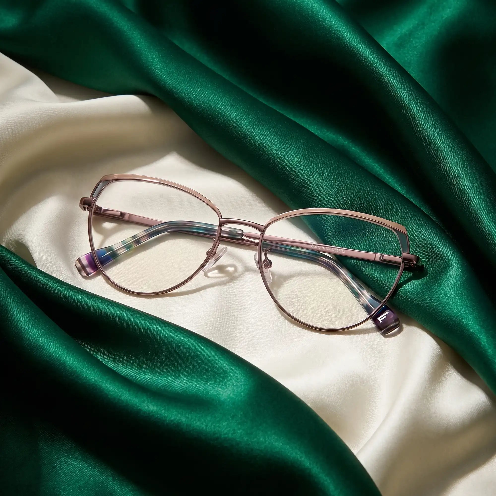 Fiore 3983 eyeglasses in grey gun – resting on draped emerald and ivory silk