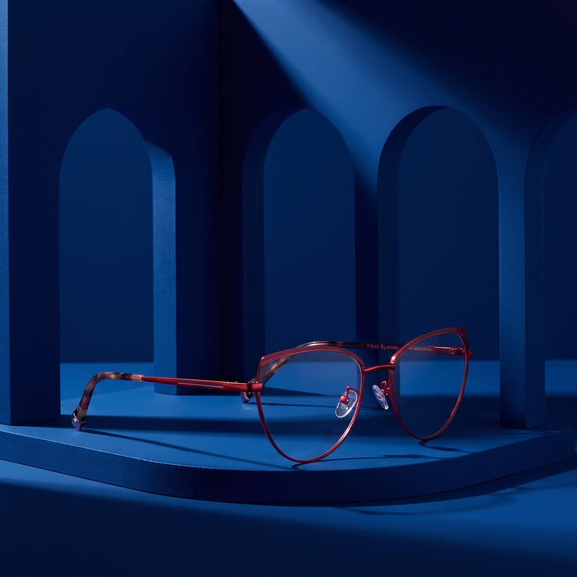 Fiore 3983 eyeglasses in red black – staged on a sculptural midnight blue architecture set