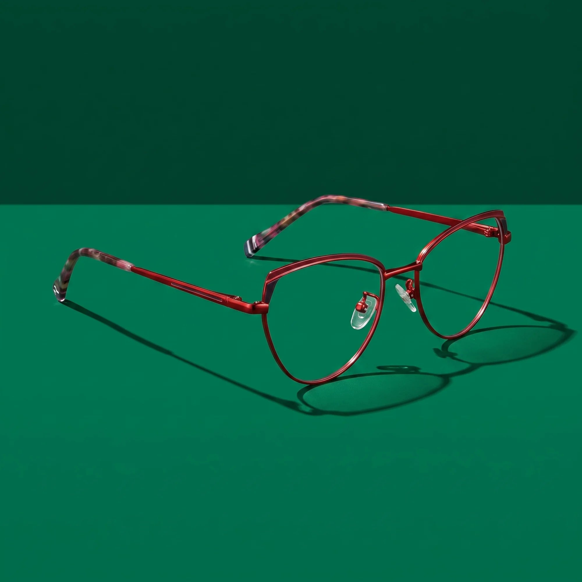 Fiore 3983 eyeglasses in red black – editorial still life on a saturated emerald set