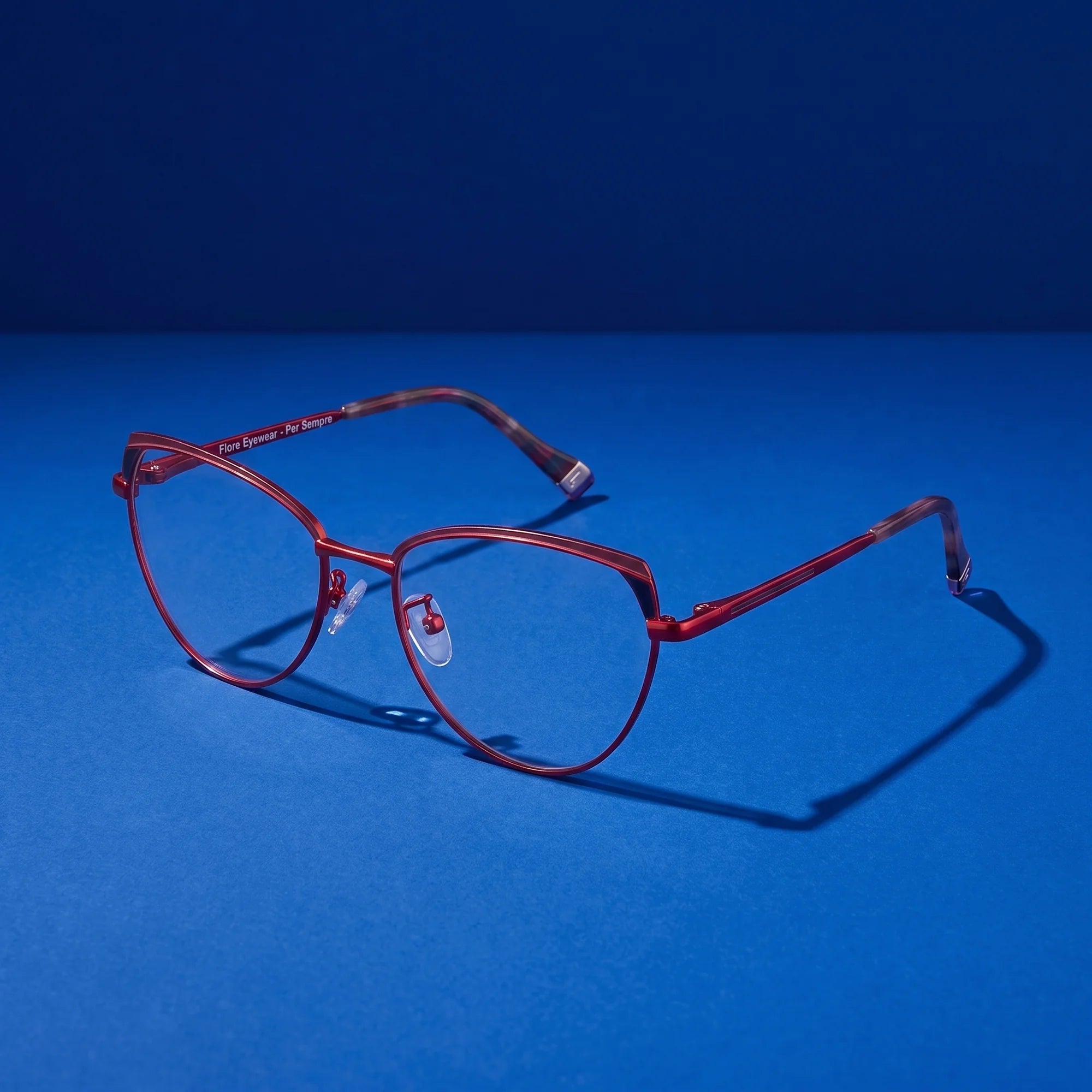 Fiore 3983 eyeglasses in red black – still life on a seamless cobalt studio backdrop