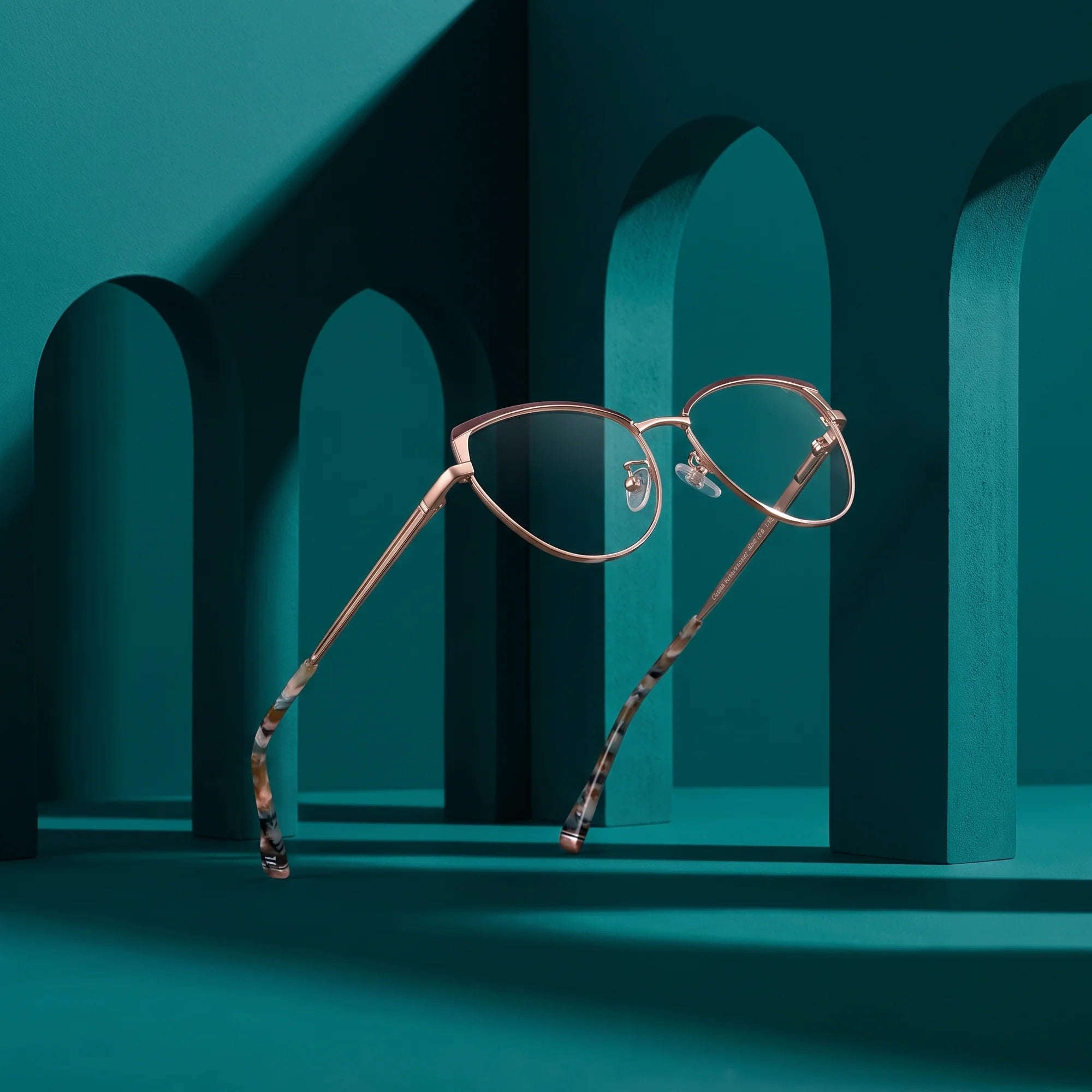 Fiore 3983 eyeglasses in brown gold – still life among monochrome teal arches