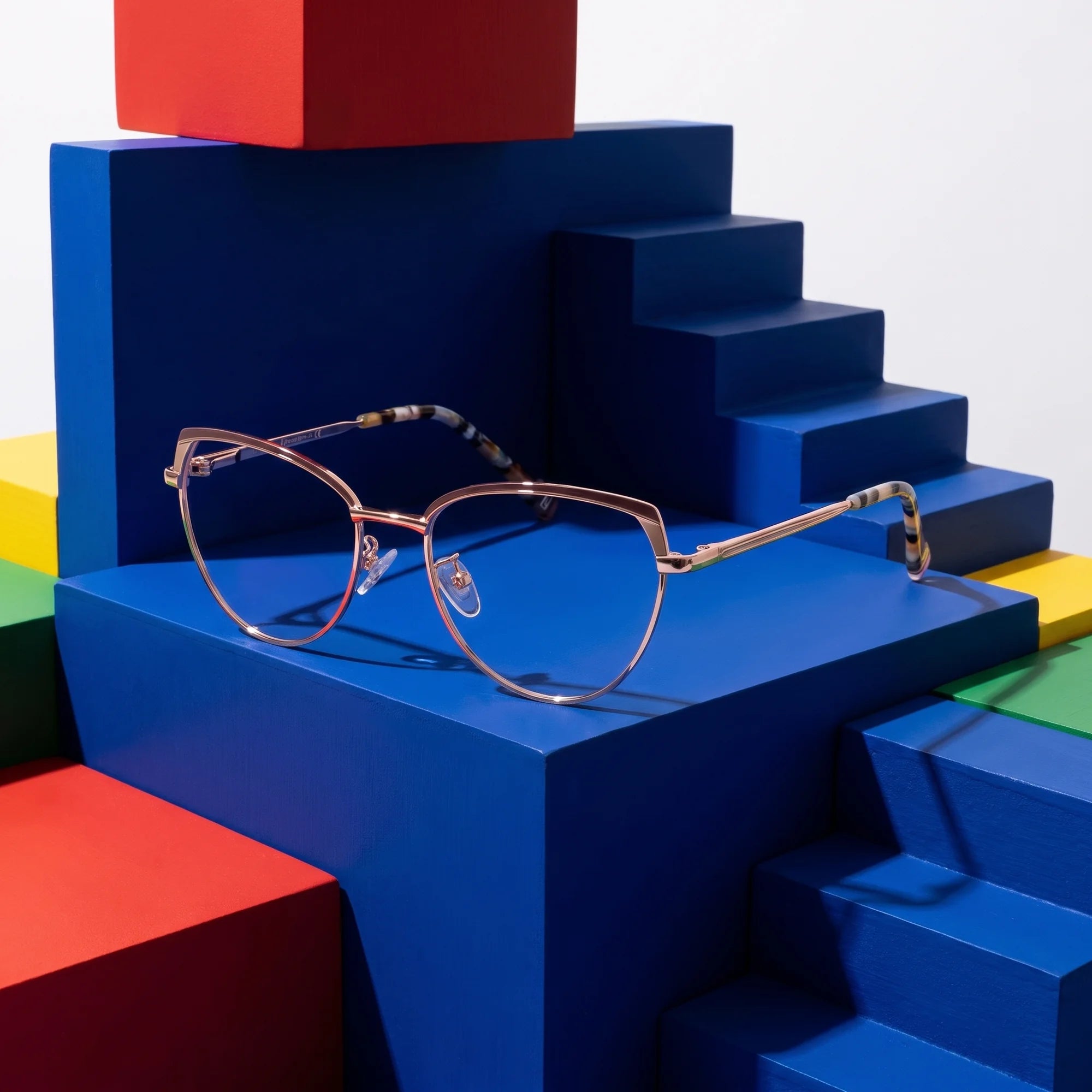 Fiore 3983 eyeglasses in brown gold – on bold primary color-block steps