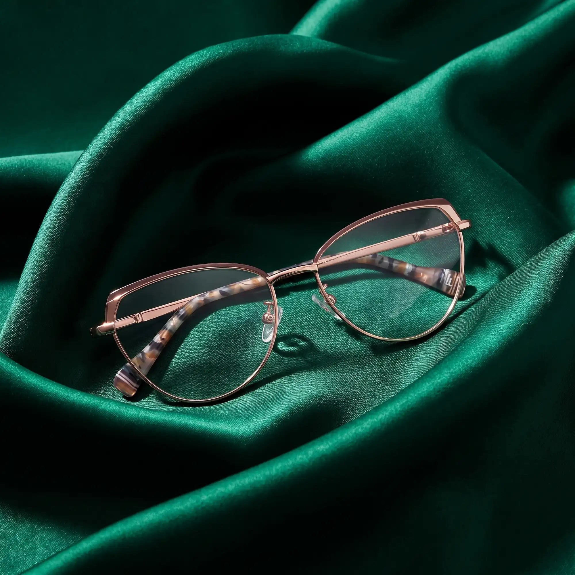 Fiore 3983 eyeglasses in brown gold – nested in flowing emerald silk