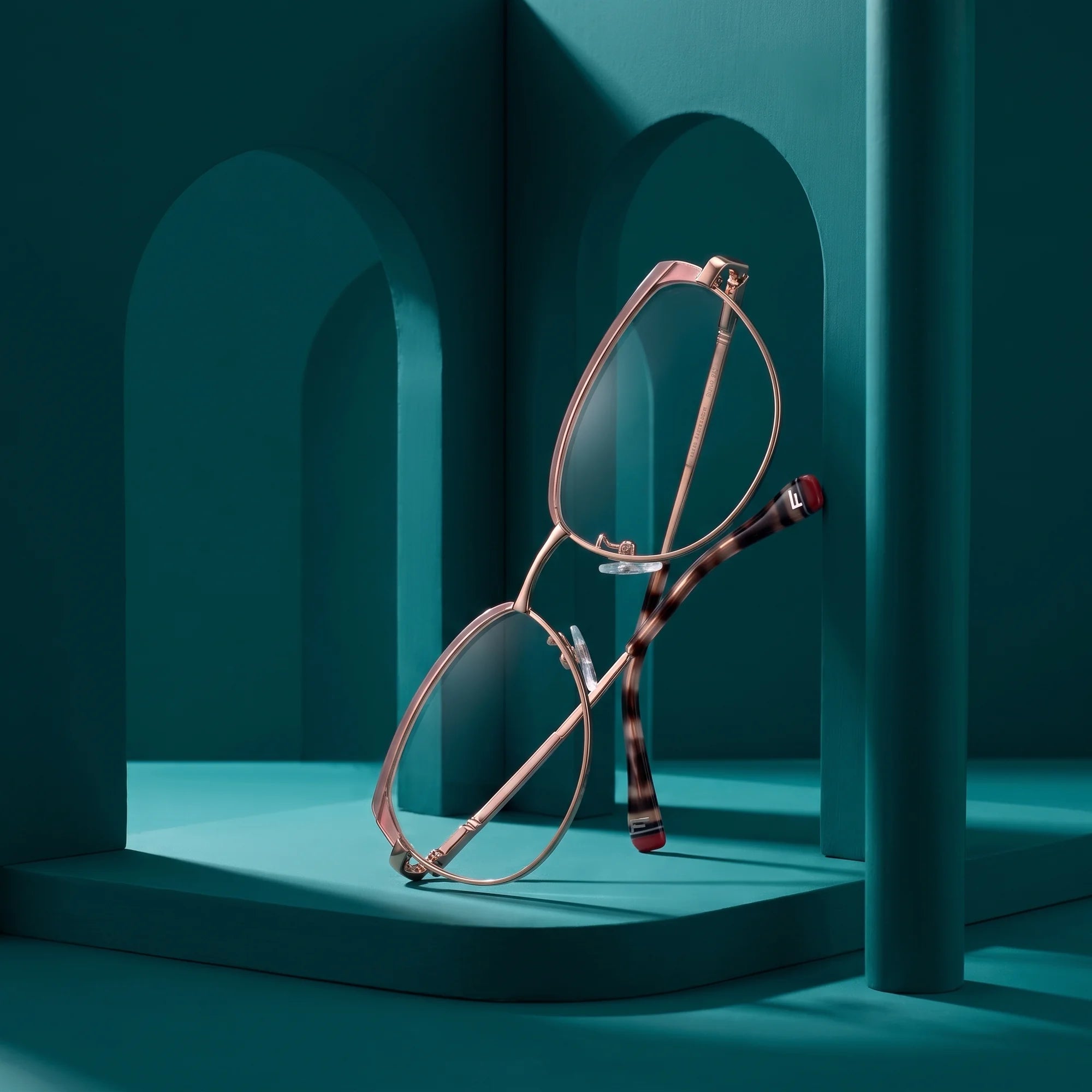 Fiore 3983 eyeglasses in pink gold – still life among monochrome teal arches