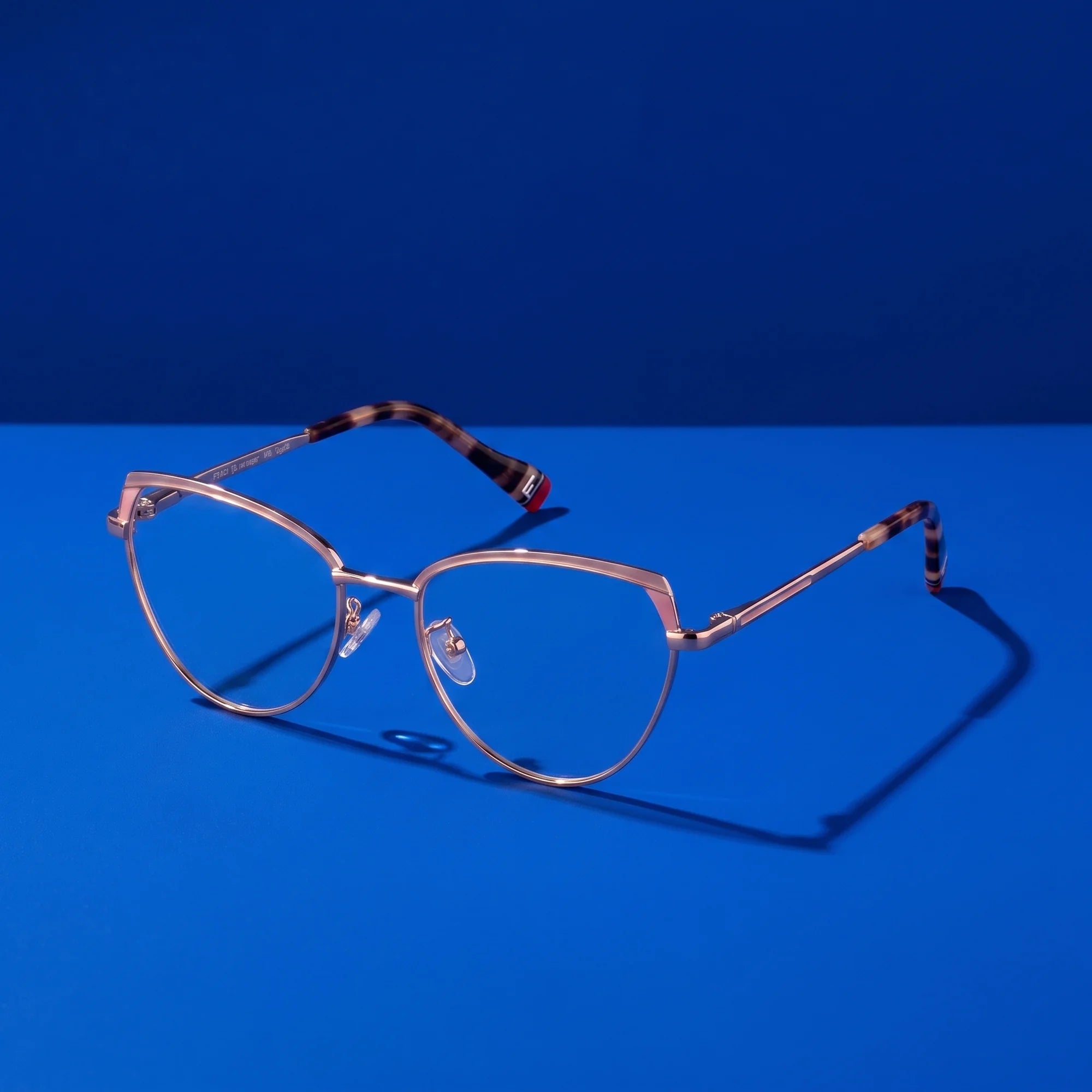 Fiore 3983 eyeglasses in pink gold – still life on a seamless cobalt studio backdrop