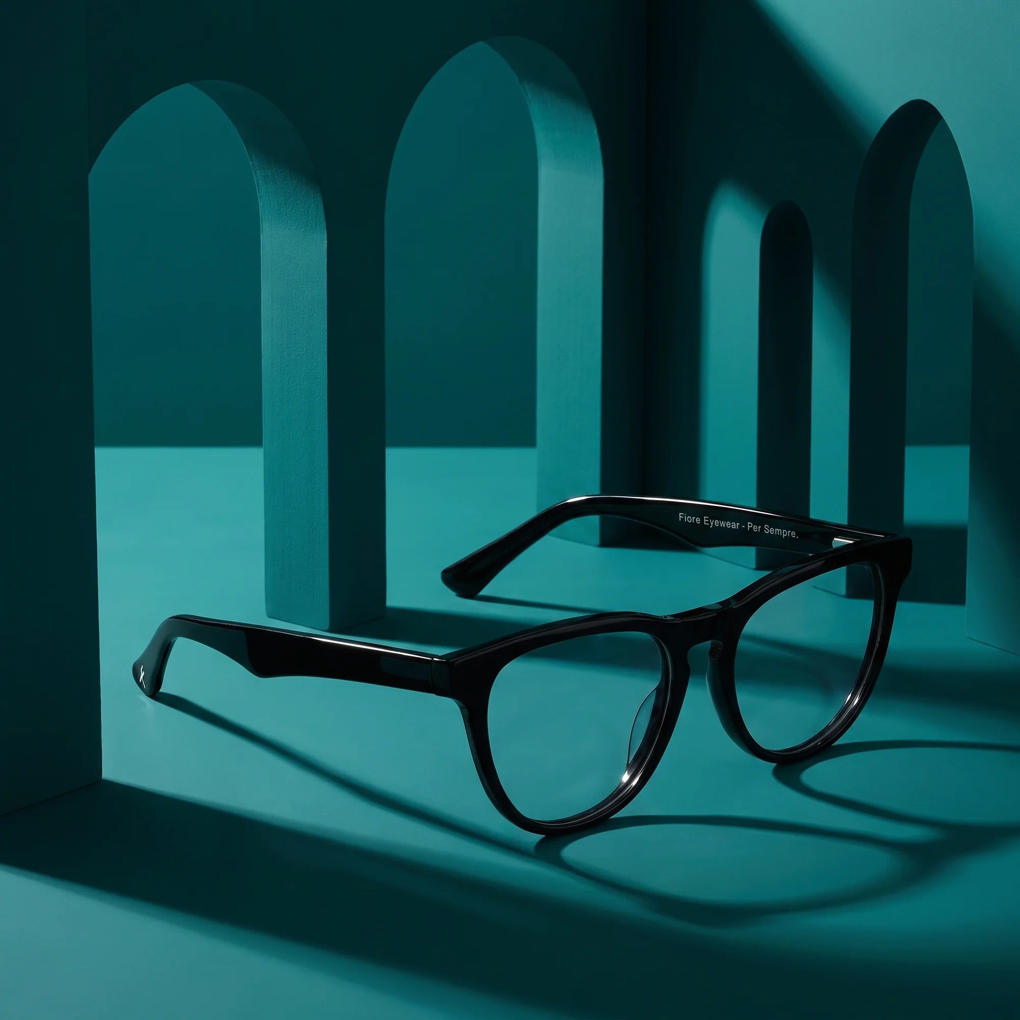 Fiore 4488 eyeglasses in black – still life among monochrome teal arches