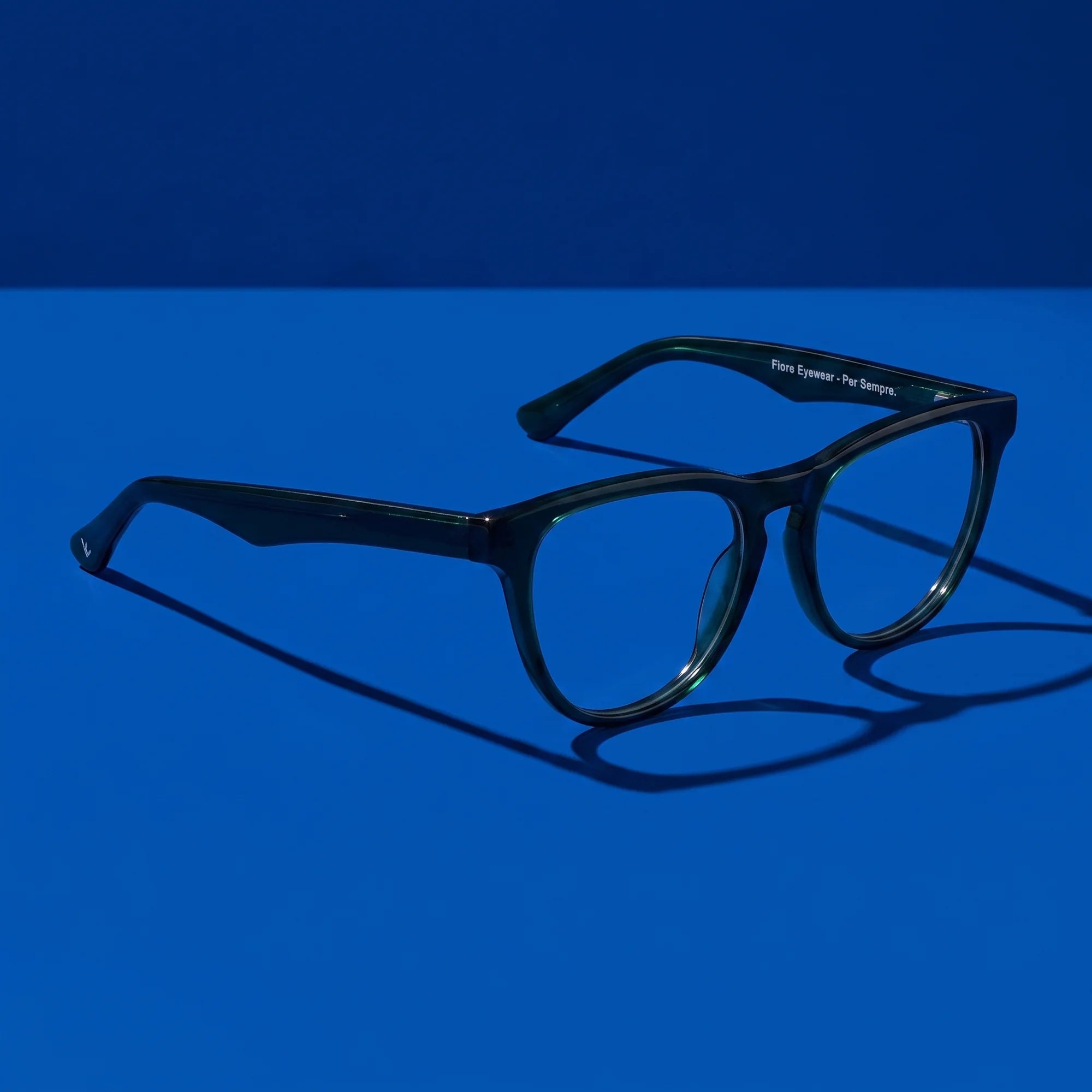 Fiore 4488 eyeglasses in green – still life on a seamless cobalt studio backdrop
