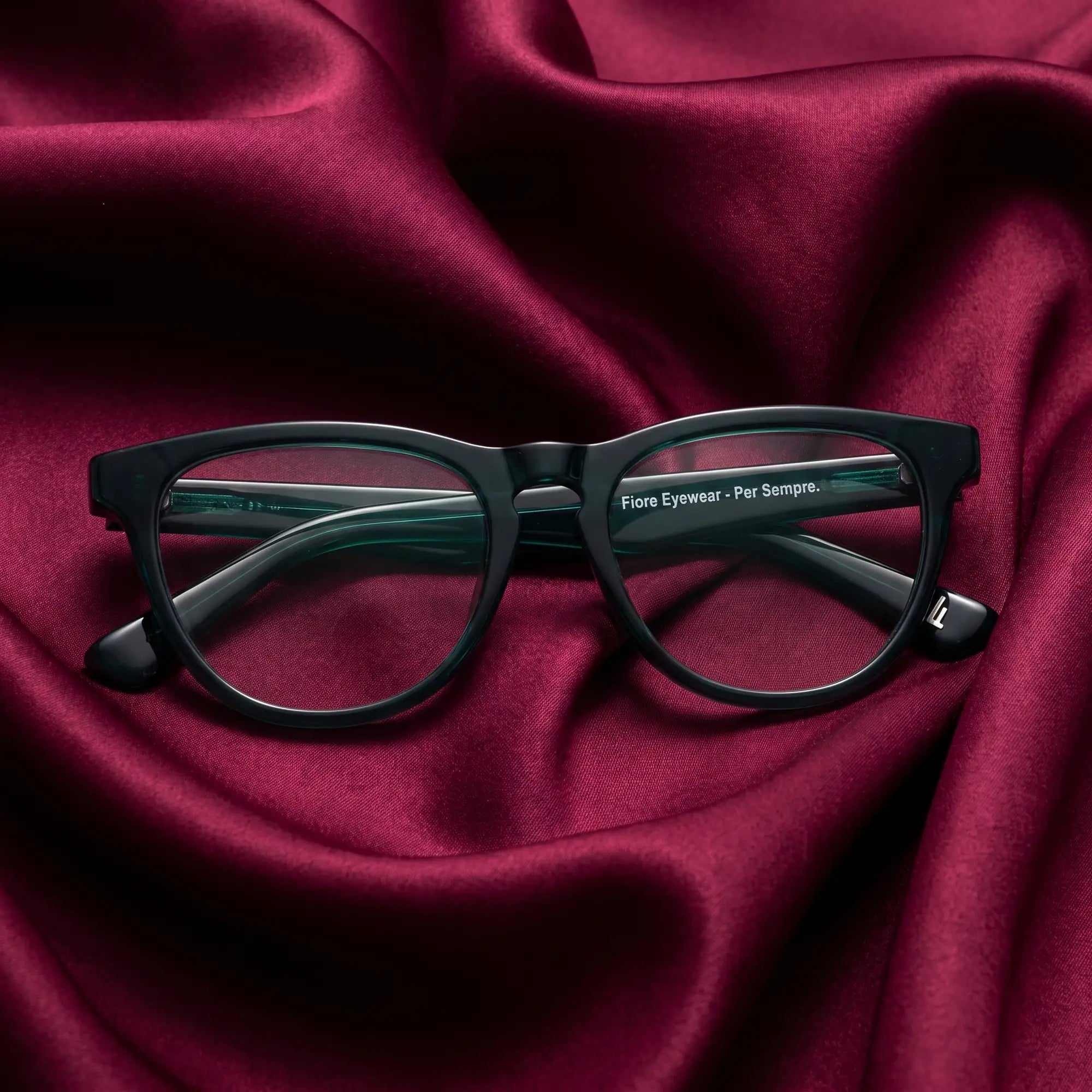 Fiore 4488 eyeglasses in green – nested in flowing burgundy silk