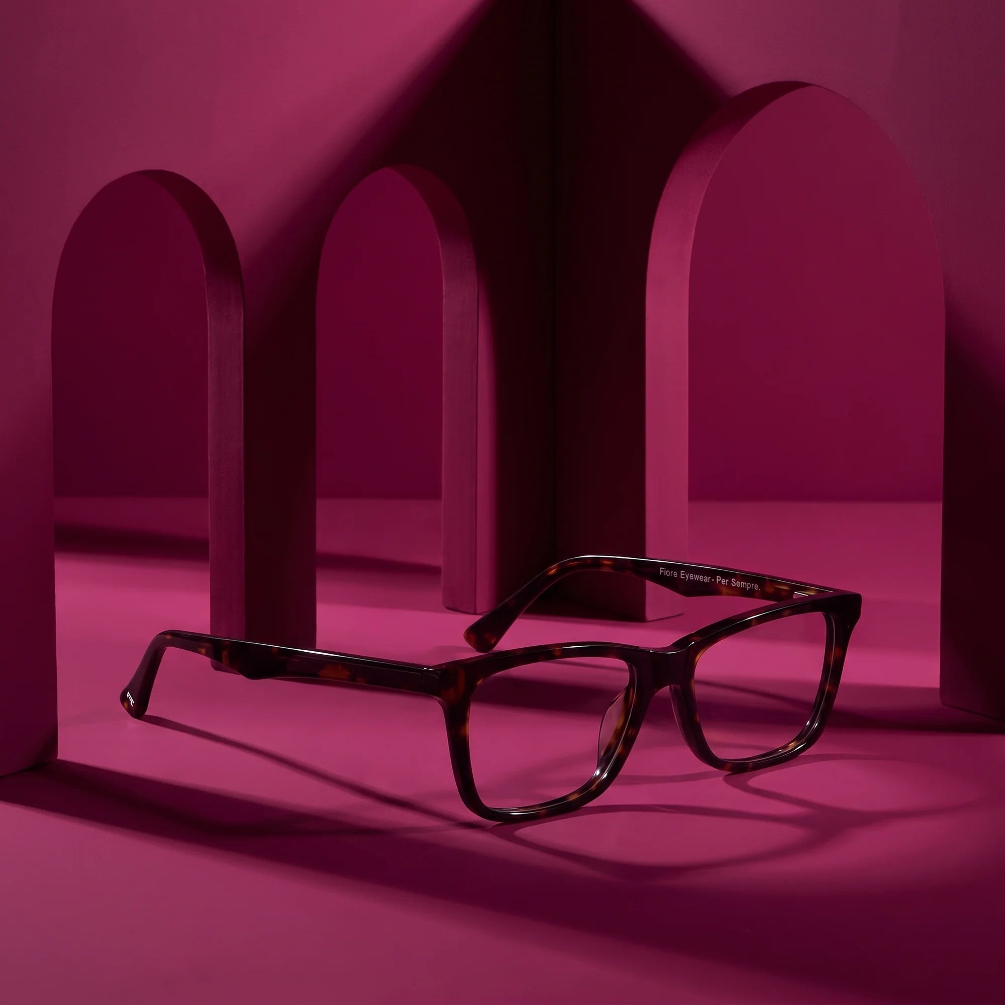 Fiore 5228 eyeglasses in tortoiseshell – staged on a sculptural magenta architecture set