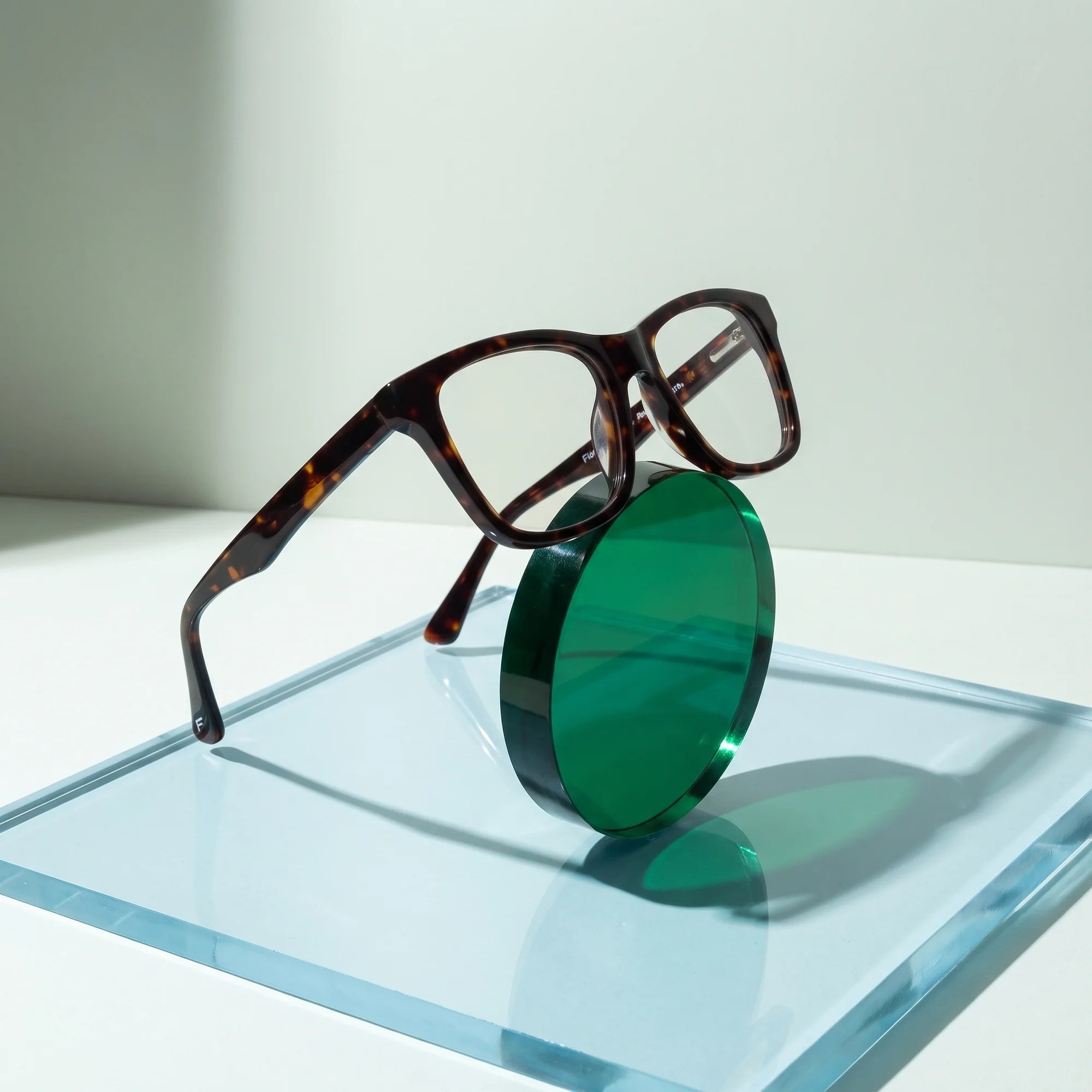 Fiore 5228 eyeglasses in tortoiseshell – on a cobalt acrylic disc in soft daylight