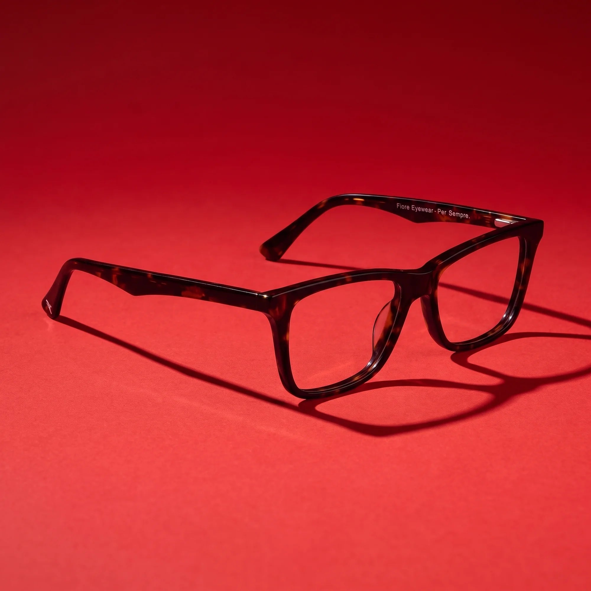 Fiore 5228 eyeglasses in tortoiseshell – editorial still life on a saturated vivid red set