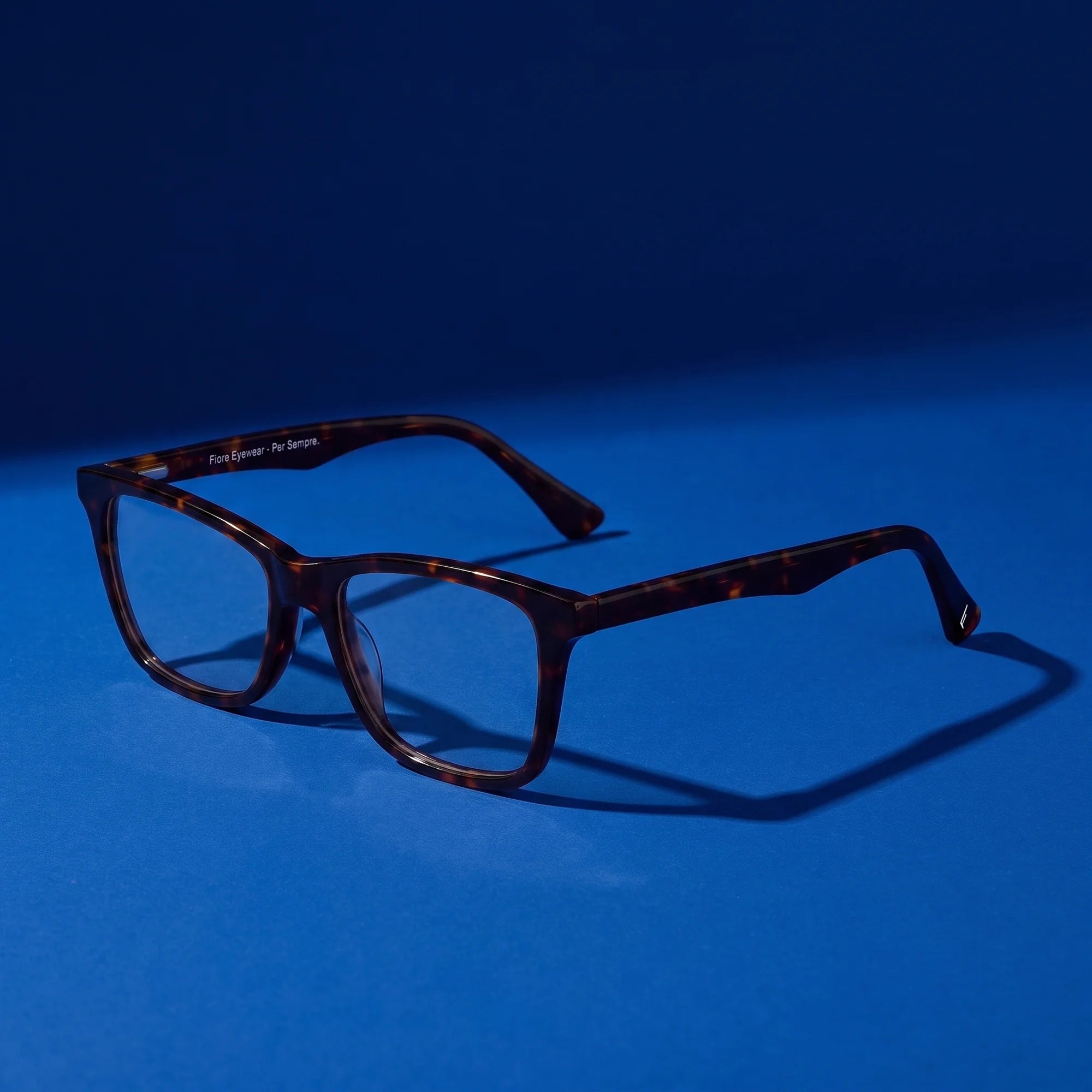 Fiore 5228 eyeglasses in tortoiseshell – hero still life against a deep cobalt backdrop