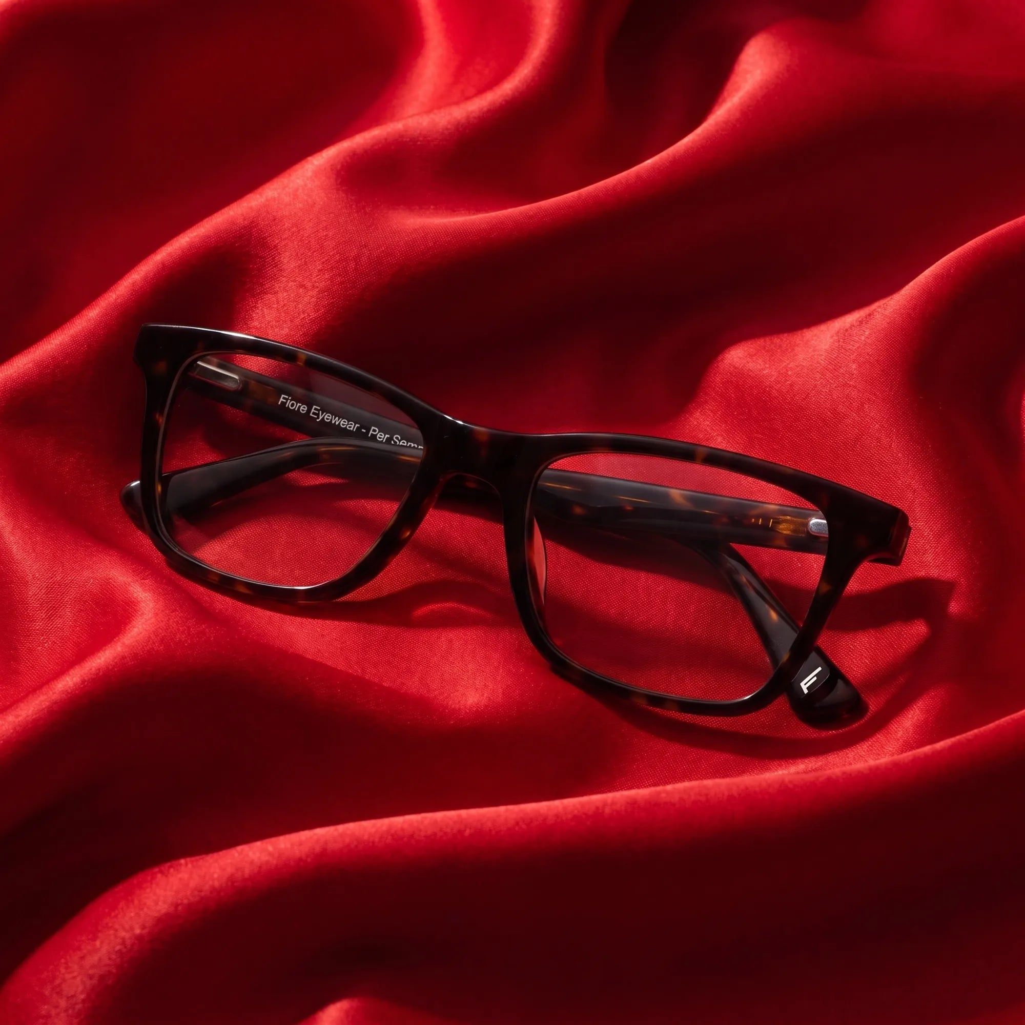 Fiore 5228 eyeglasses in tortoiseshell – nested in flowing vivid red silk