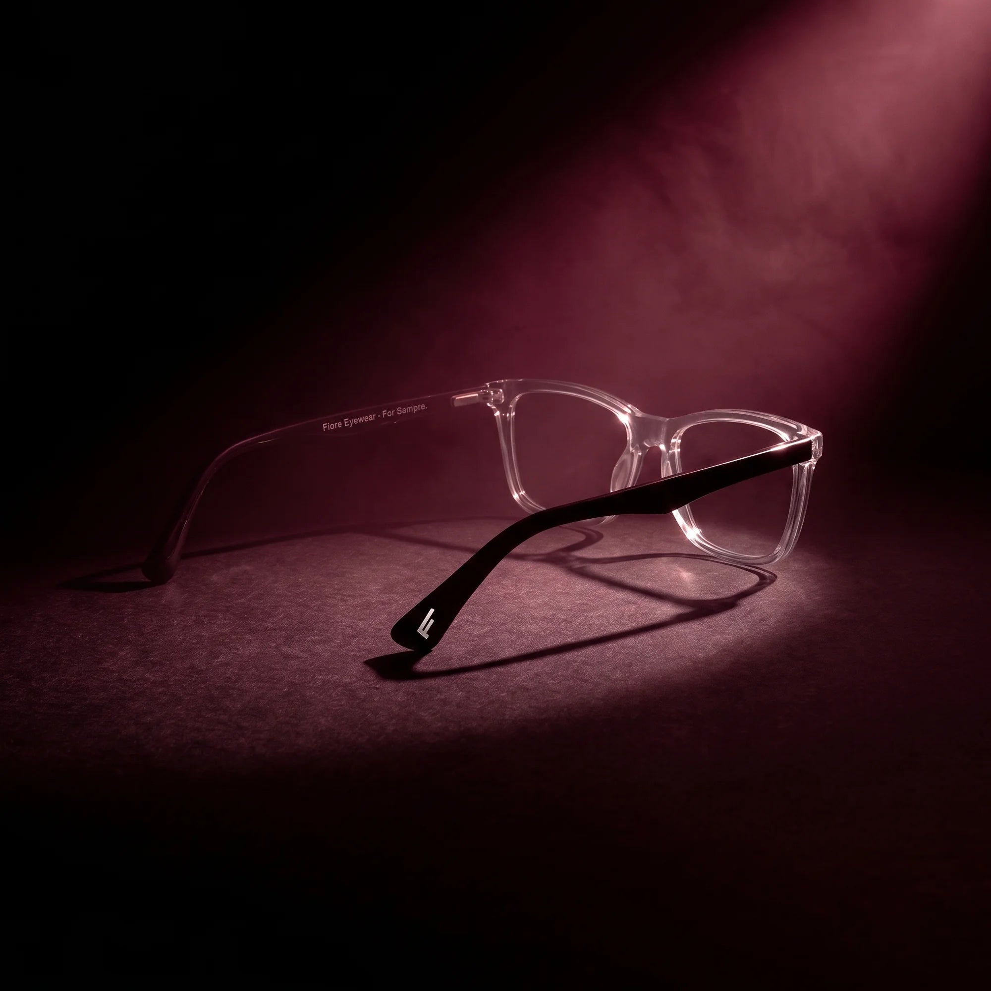 Fiore 5228 eyeglasses in transparent – under a theatrical beam of light