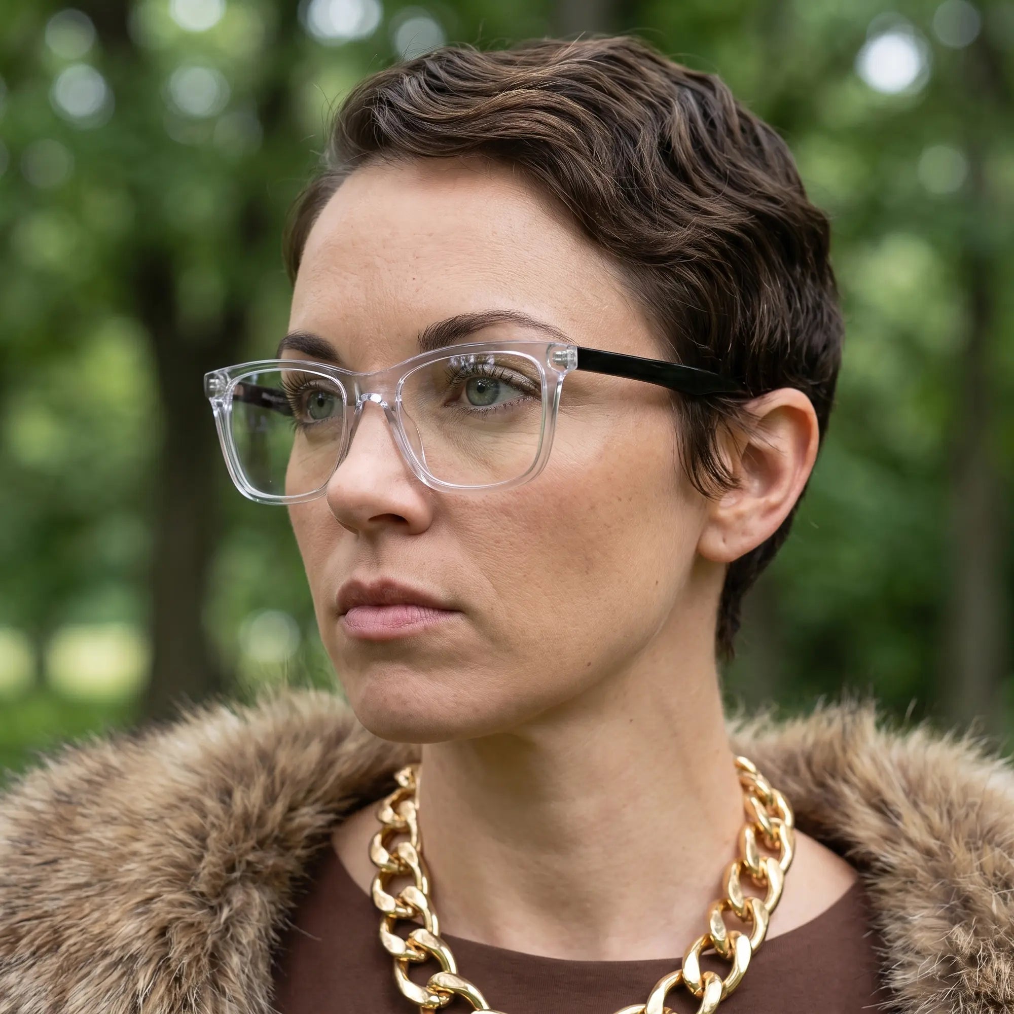 Fiore 5228 eyeglasses in transparent, worn by a model – campaign portrait, fur-collar portrait in dappled daylight