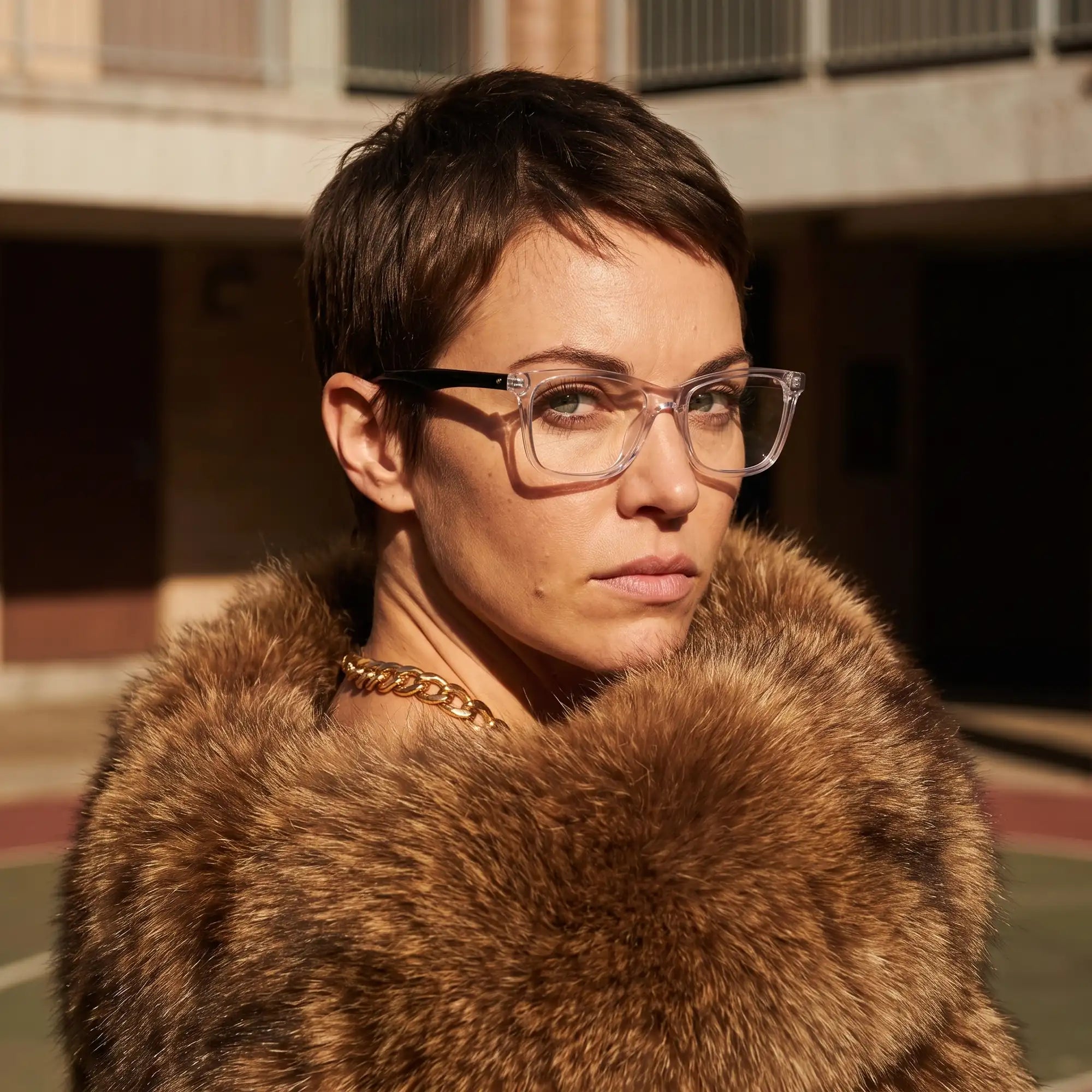 Fiore 5228 eyeglasses in transparent, worn by a model – campaign portrait, street portrait rooted in city heritage
