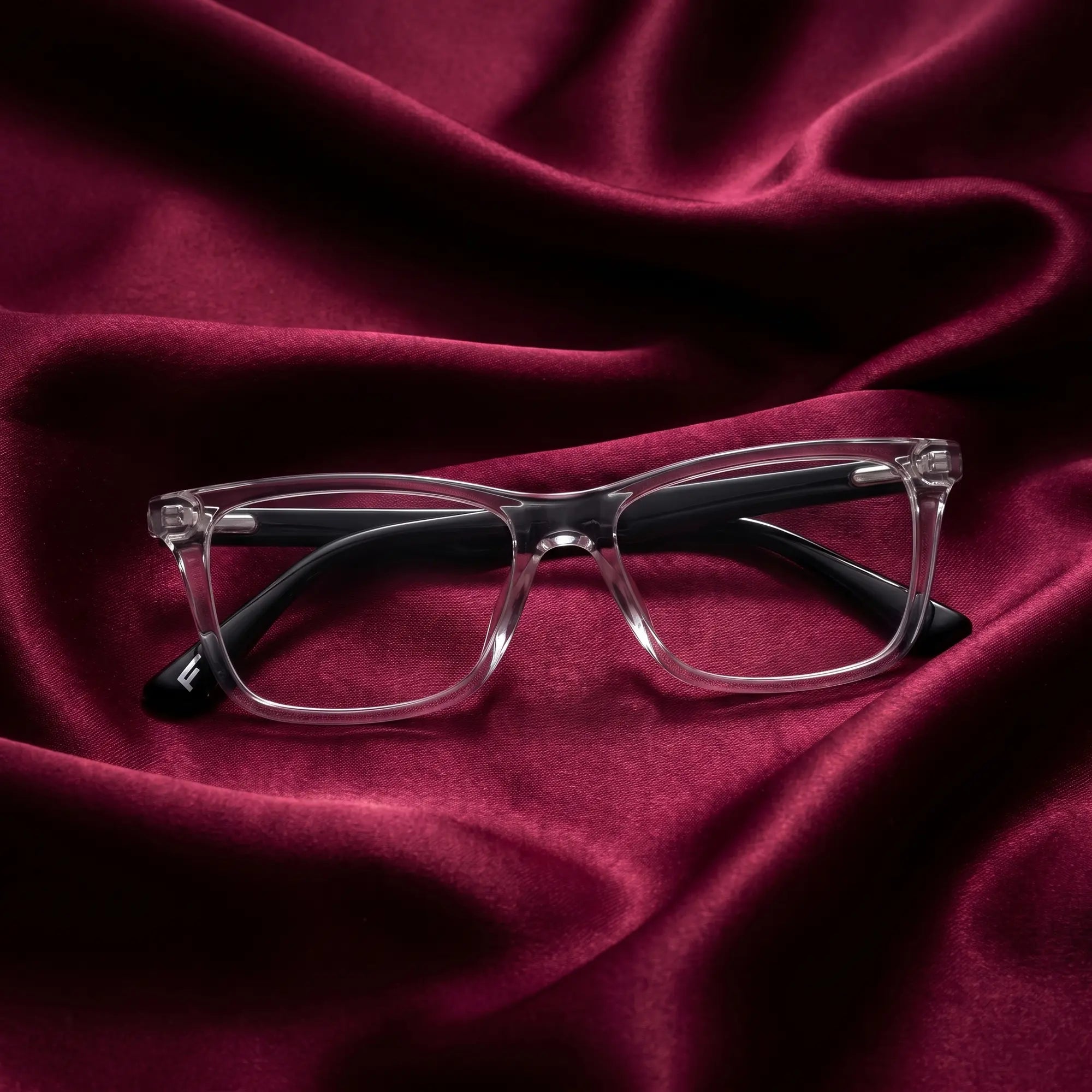 Fiore 5228 eyeglasses in transparent – nested in flowing burgundy silk
