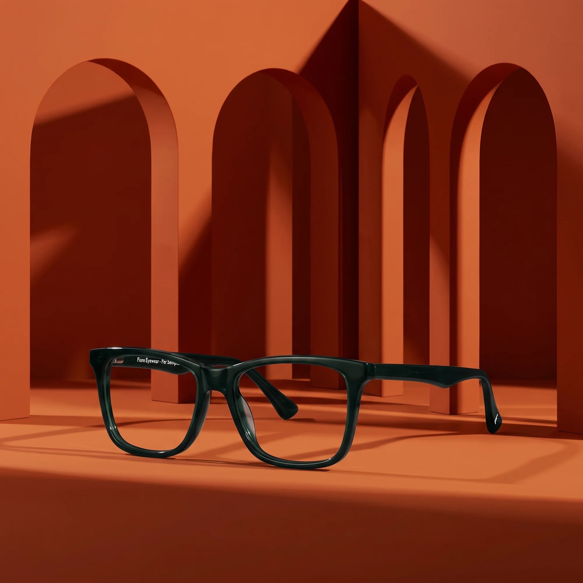 Fiore 5228 eyeglasses in green – staged on a sculptural burnt orange architecture set