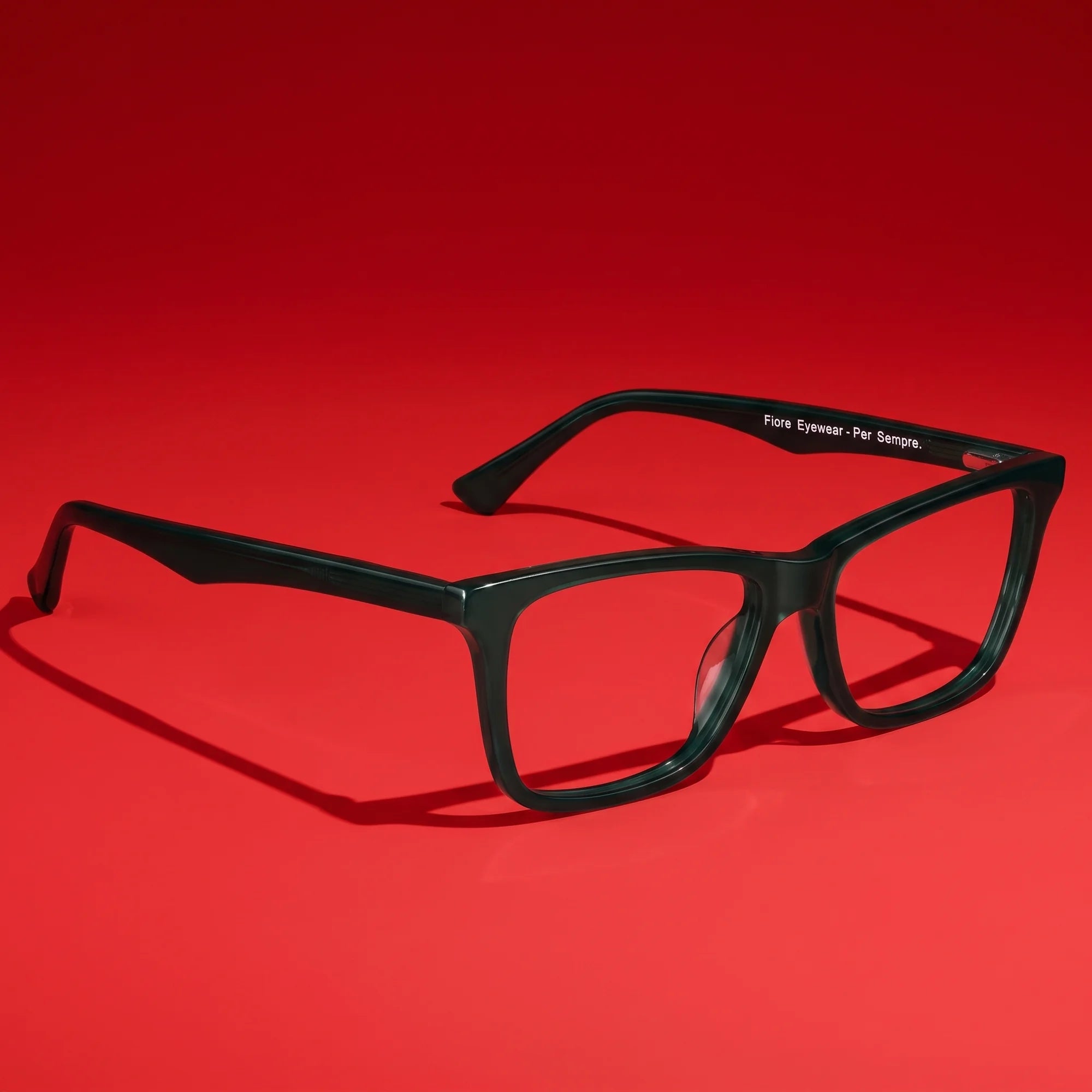 Fiore 5228 eyeglasses in green – editorial still life on a saturated vivid red set