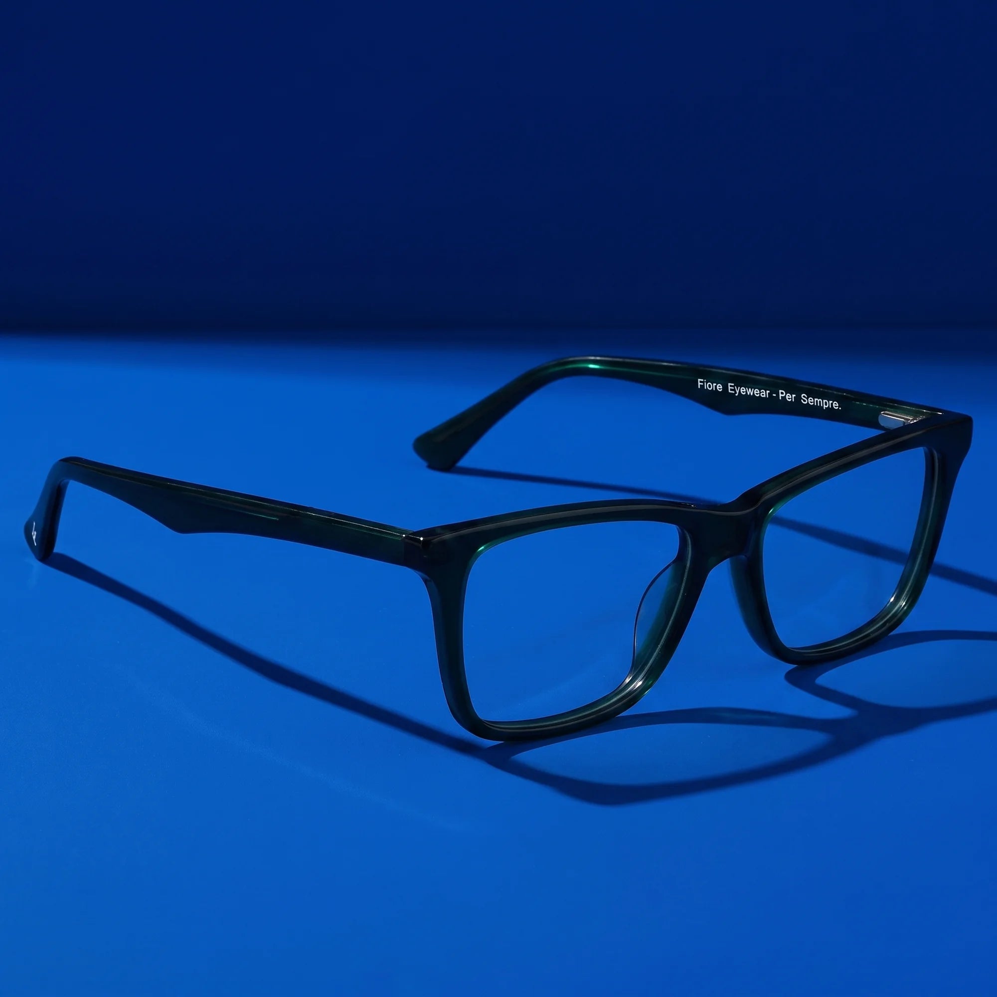 Fiore 5228 eyeglasses in green – still life on a seamless cobalt studio backdrop