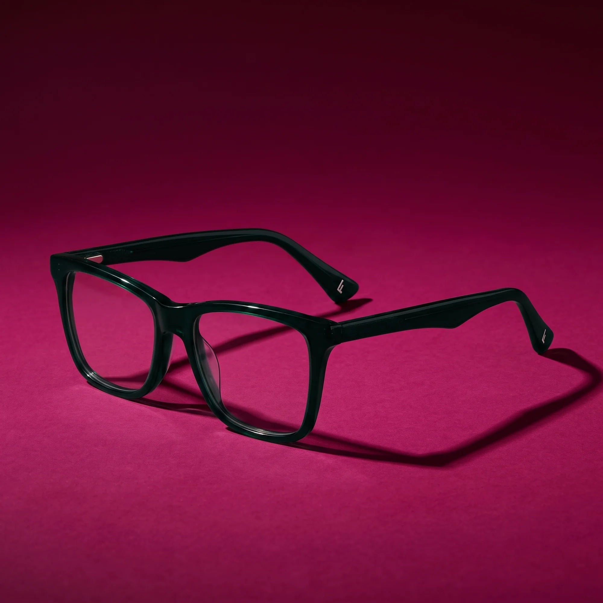 Fiore 5228 eyeglasses in green – hero still life against a deep magenta backdrop