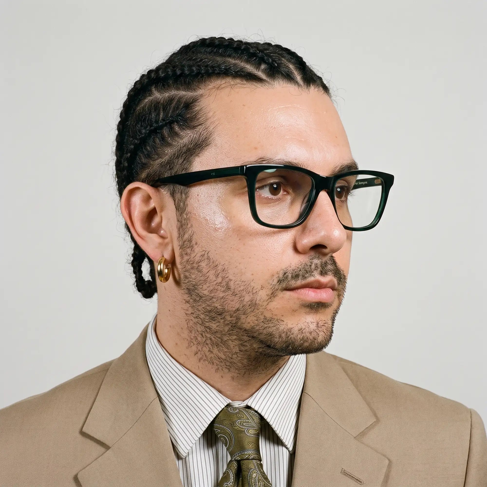 Fiore 5228 eyeglasses in green, worn by a model – campaign portrait, clean beige studio three-quarter portrait