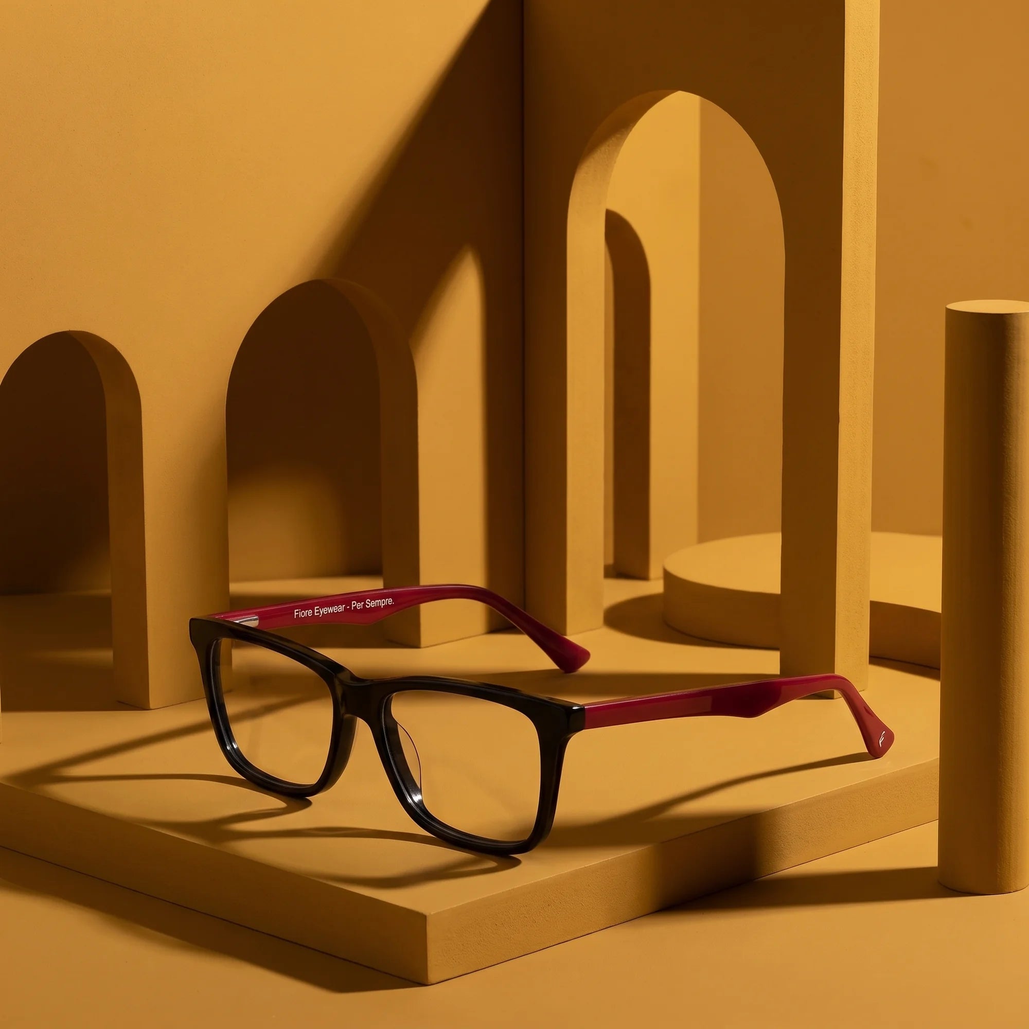 Fiore 5228 eyeglasses in black – still life among monochrome mustard ochre arches