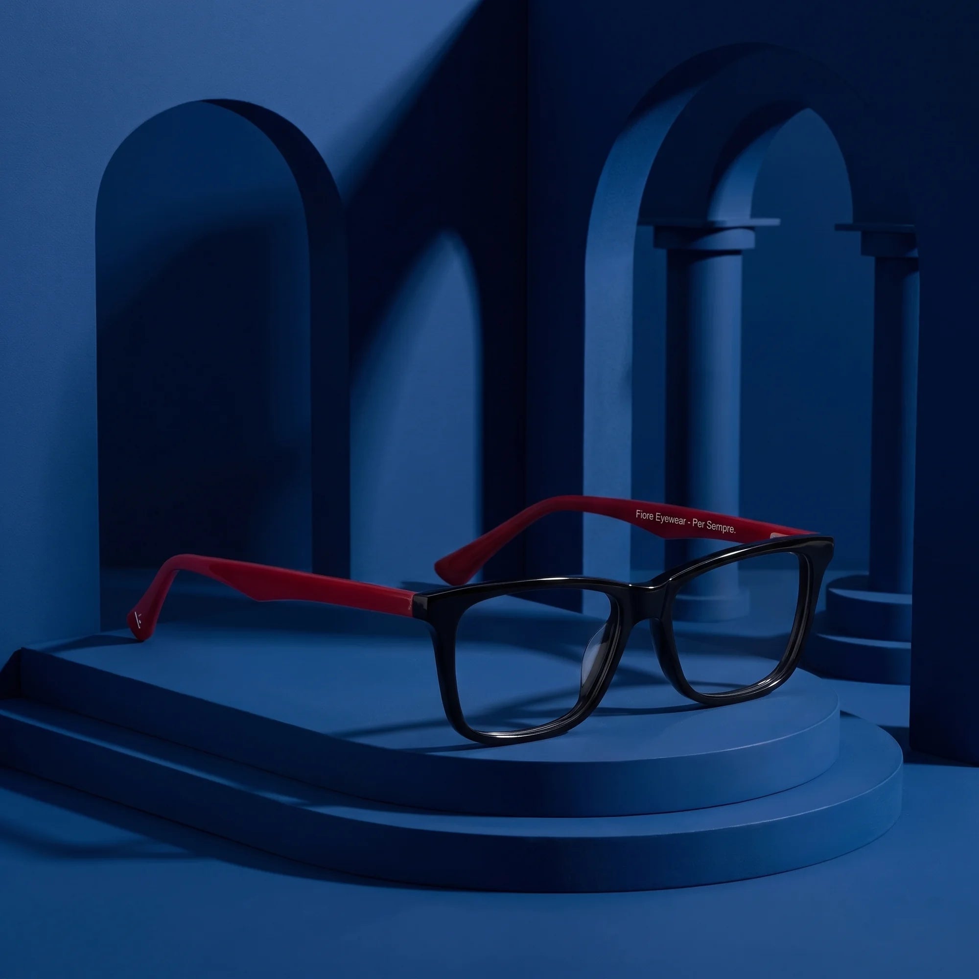 Fiore 5228 eyeglasses in black – displayed on a midnight blue podium among arches