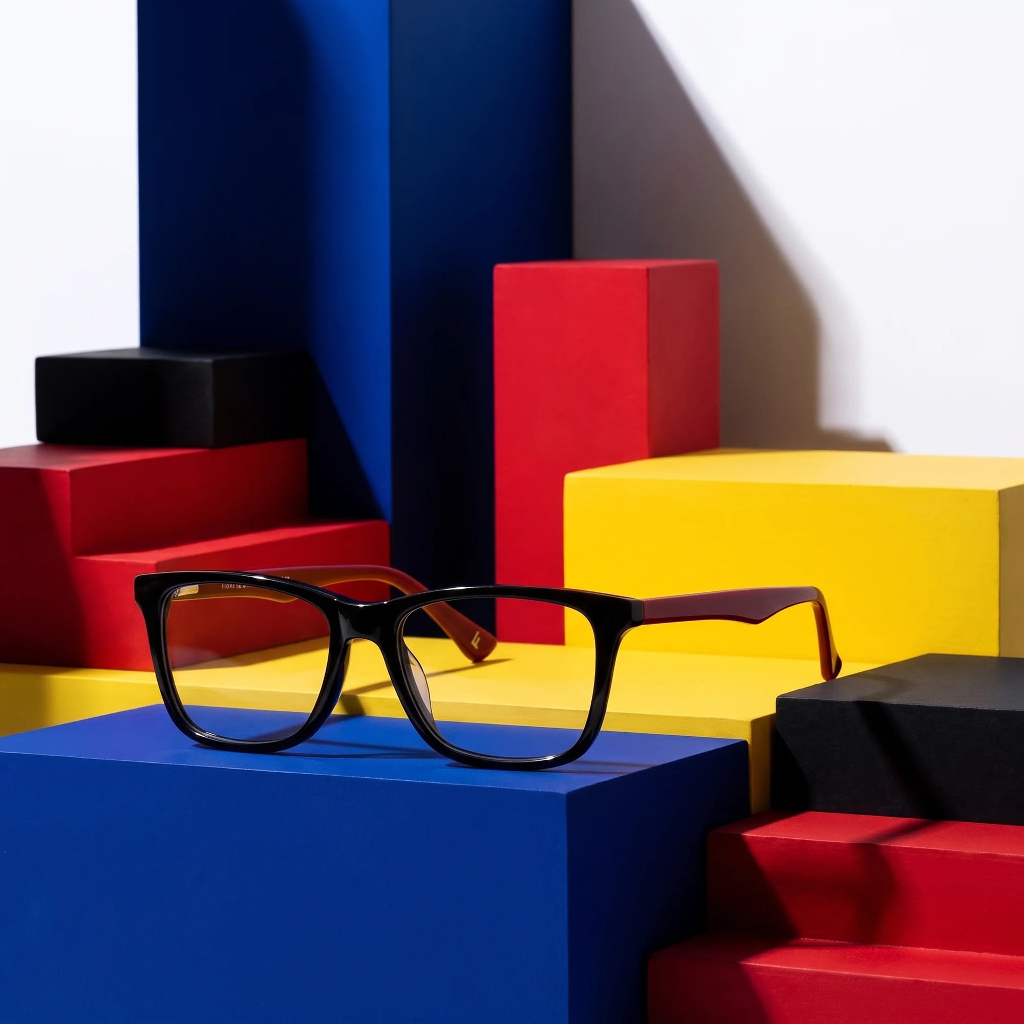 Fiore 5228 eyeglasses in black – on bold primary color-block steps