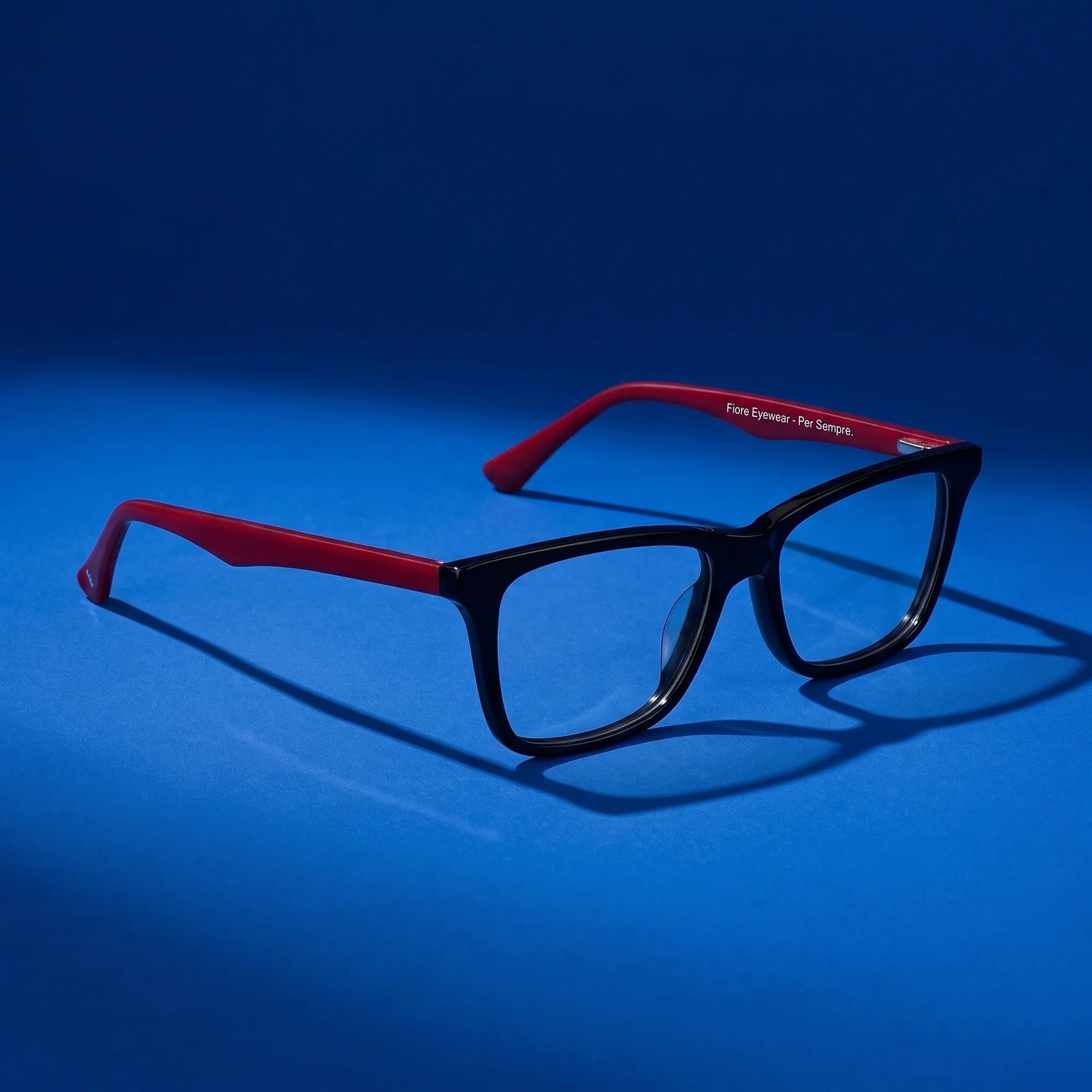 Fiore 5228 eyeglasses in black – still life on a seamless cobalt studio backdrop